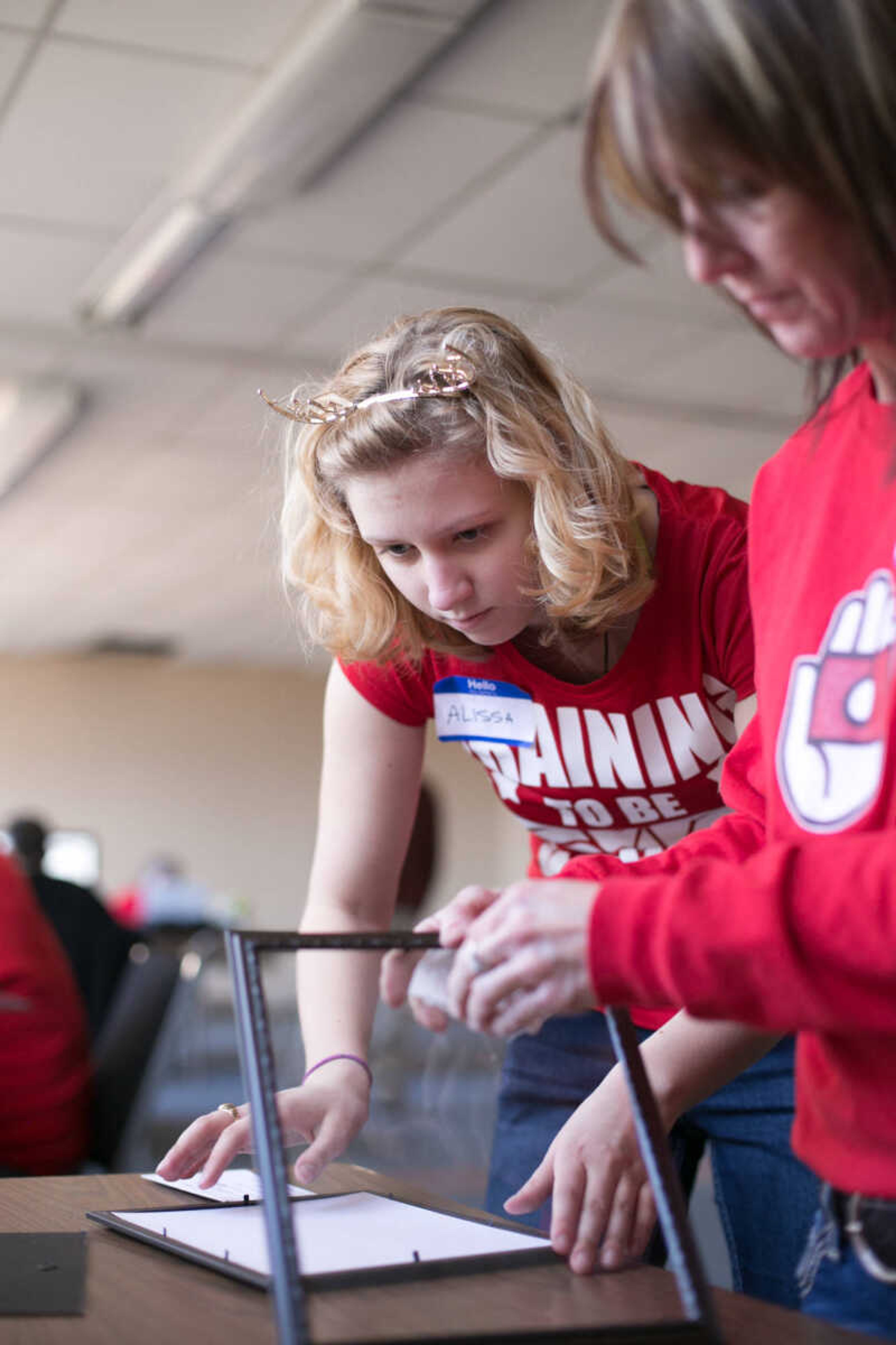 GLENN LANDBERG ~ glandberg@semissourian.com

Alissa Wiggs frames a family photo taken during the Help-Portrait event at the House of Hope Saturday, Dec. 5, 2015 in Cape Girardeau.