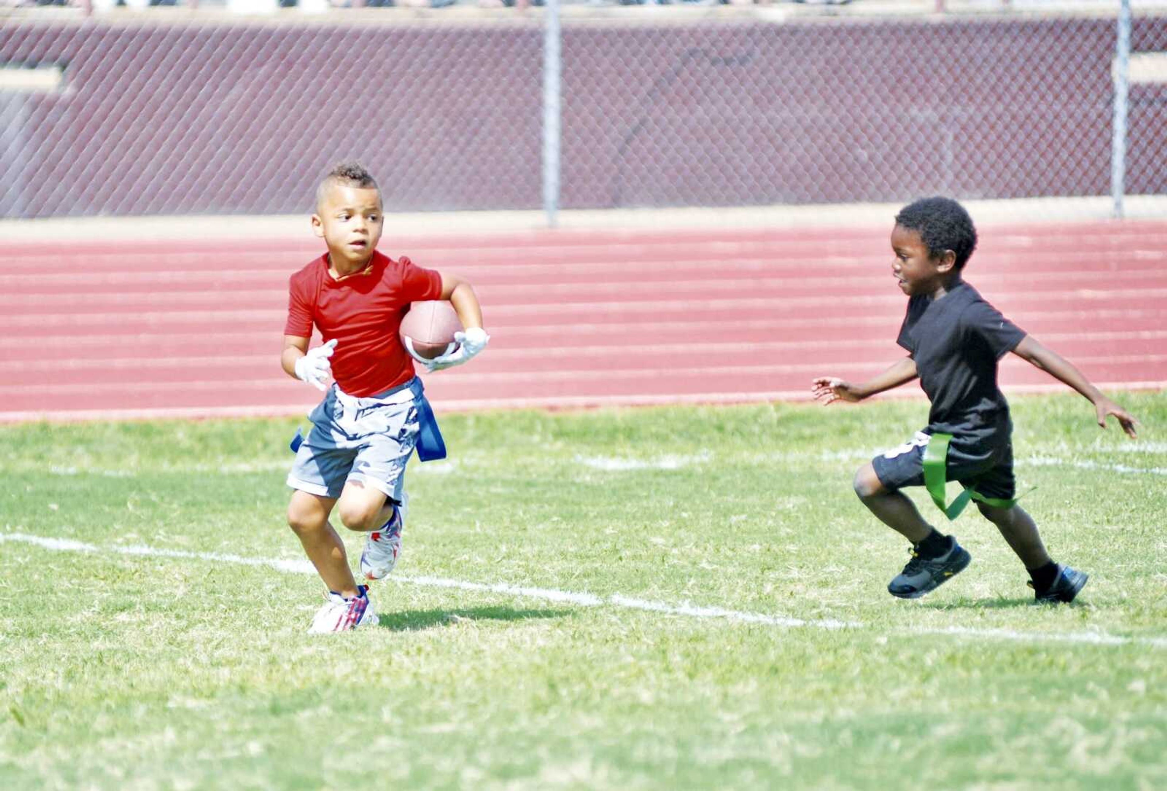 A running back from Team Alabama moves down field as he looks toward the defense.