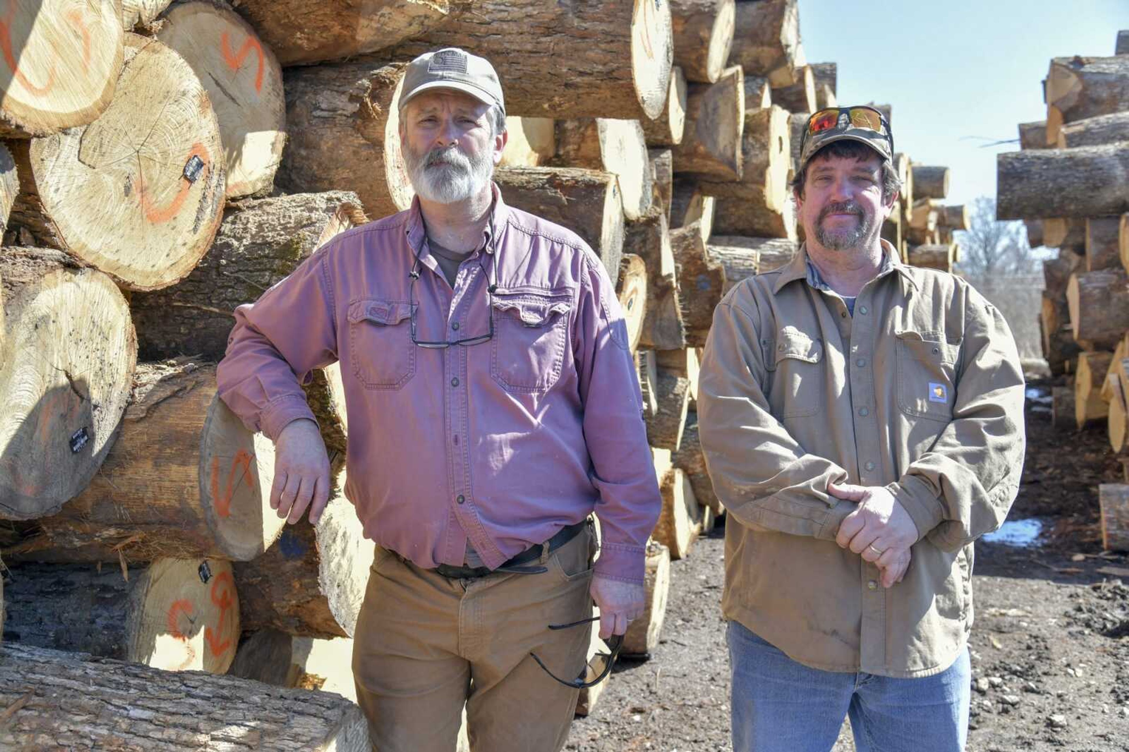 Perryville Stave Co. president Steve Bailey, left, and general manager Mike Bailey, who are brothers, pose for a portrait Thursday near a stack of American white oak logs that will be processed into staves at the company in Perryville, Missouri.