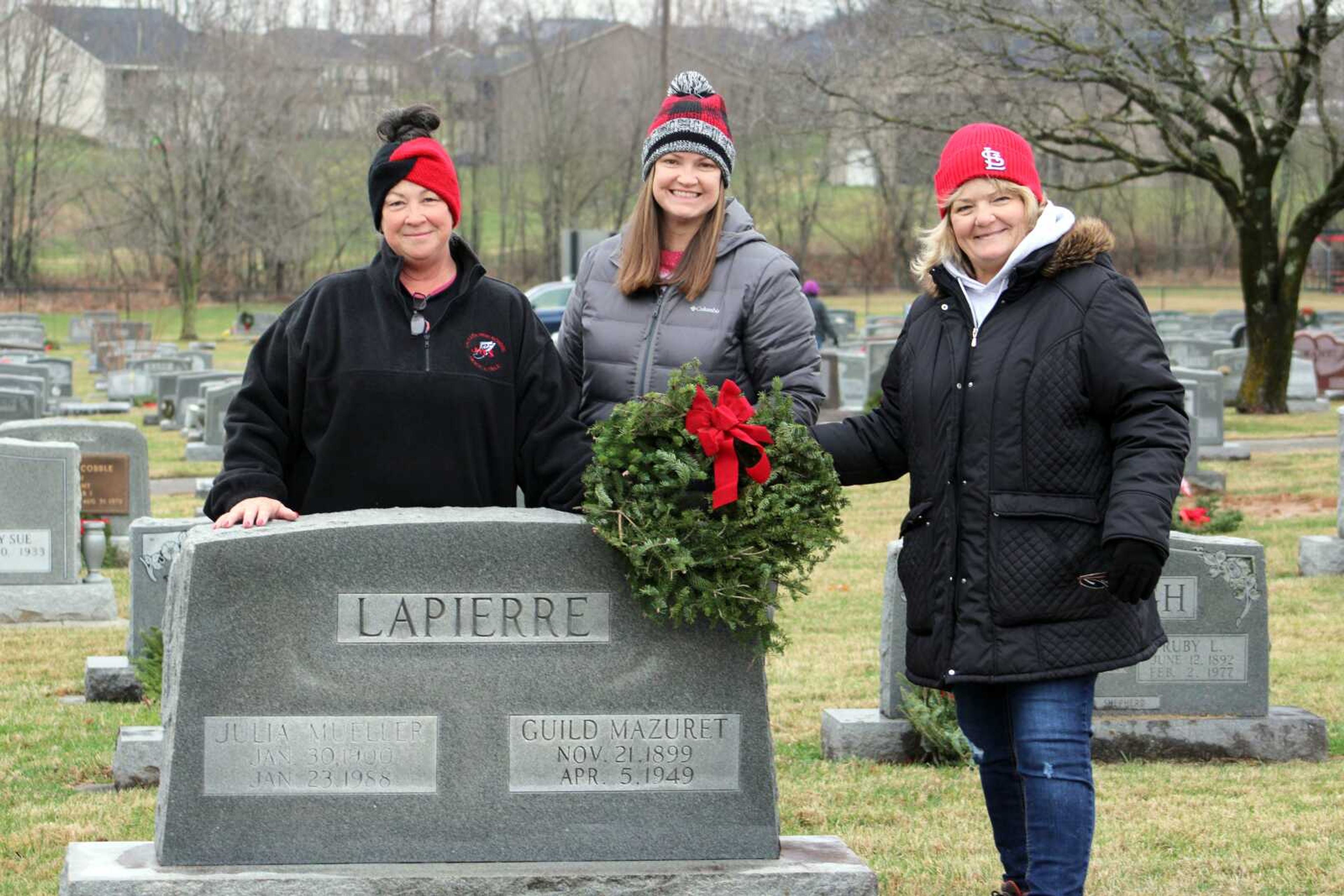 Linda Venable, Martha Venable and Jessica Teague hold a wreath in front of the headstone of a veteran in their family for National Wreaths Across America Day on Saturday at Russell Heights cemetery in Jackson. Volunteers in Jackson joined more than 2,700 other locations across the country for National Wreaths Across America Day, which is coordinated and led by local volunteers and fundraising groups seeking to further the WAA mission of Remember, Honor and Teach, ensuring the memory of veterans endures.