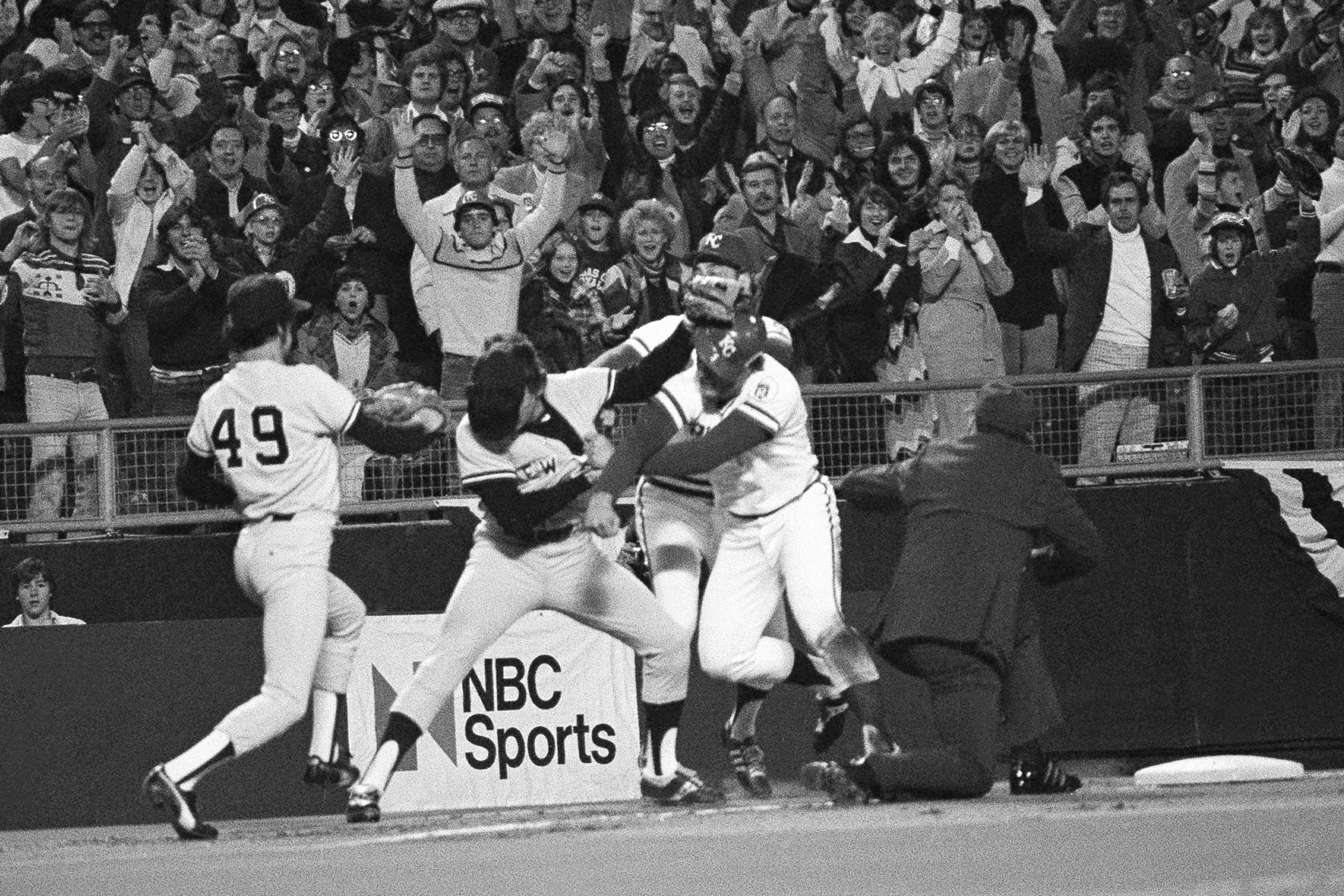 FILE- Kansas City Royals third baseman George Brett, right, rights with New York Yankees third baseman Graig Nettles in the first inning of Game 5, the final of the American League playoffs at Kansas City, Oct. 9, 1977. (AP Photo, File)