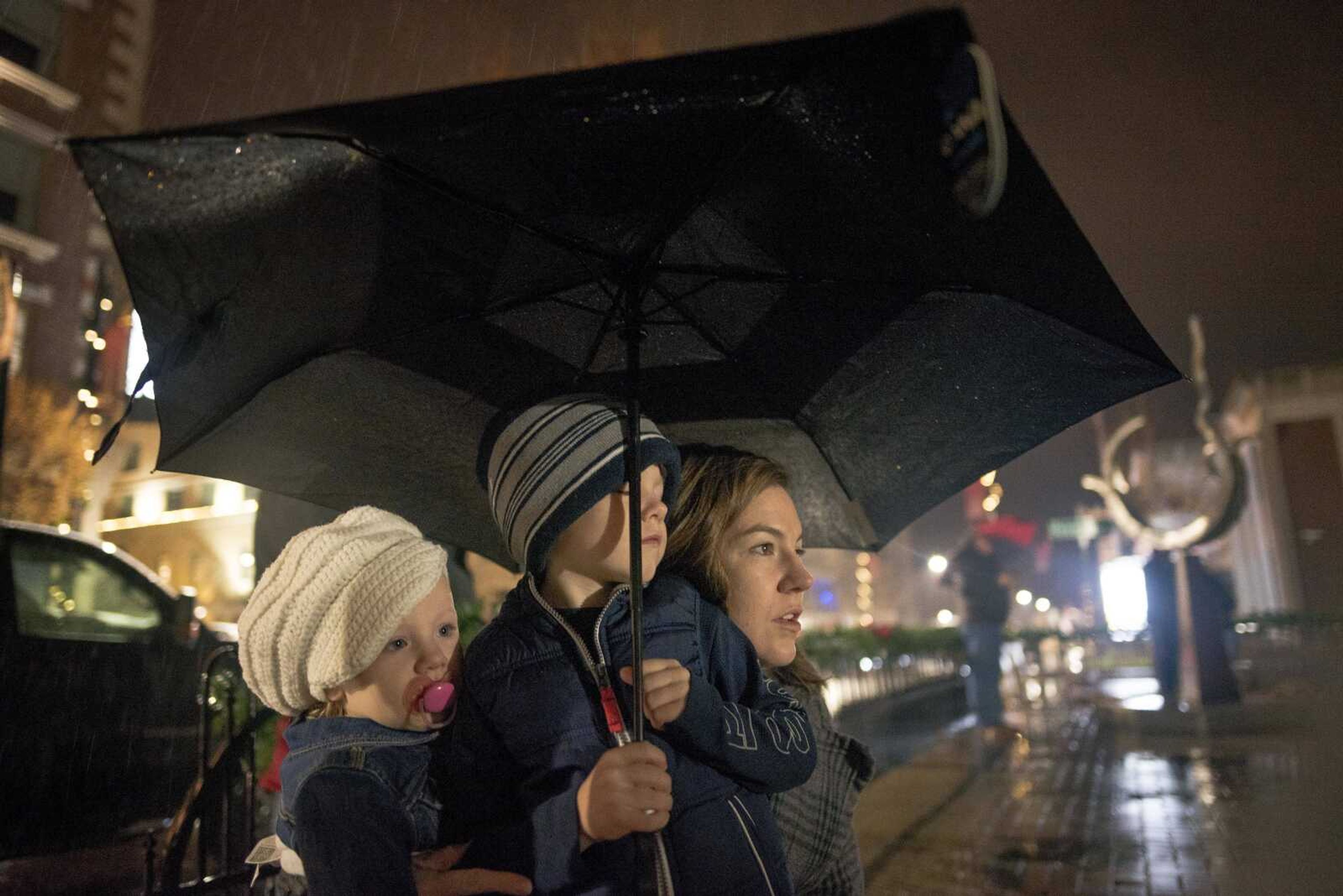 Katie Urhahn, right, looks to the tree with children Abe, center, 4, and Mia, left, 1, during the inaugural Christmas tree lighting hosted by Old Town Cape Friday, Nov. 29, 2019, at the Vasterling Suites in Cape Girardeau.