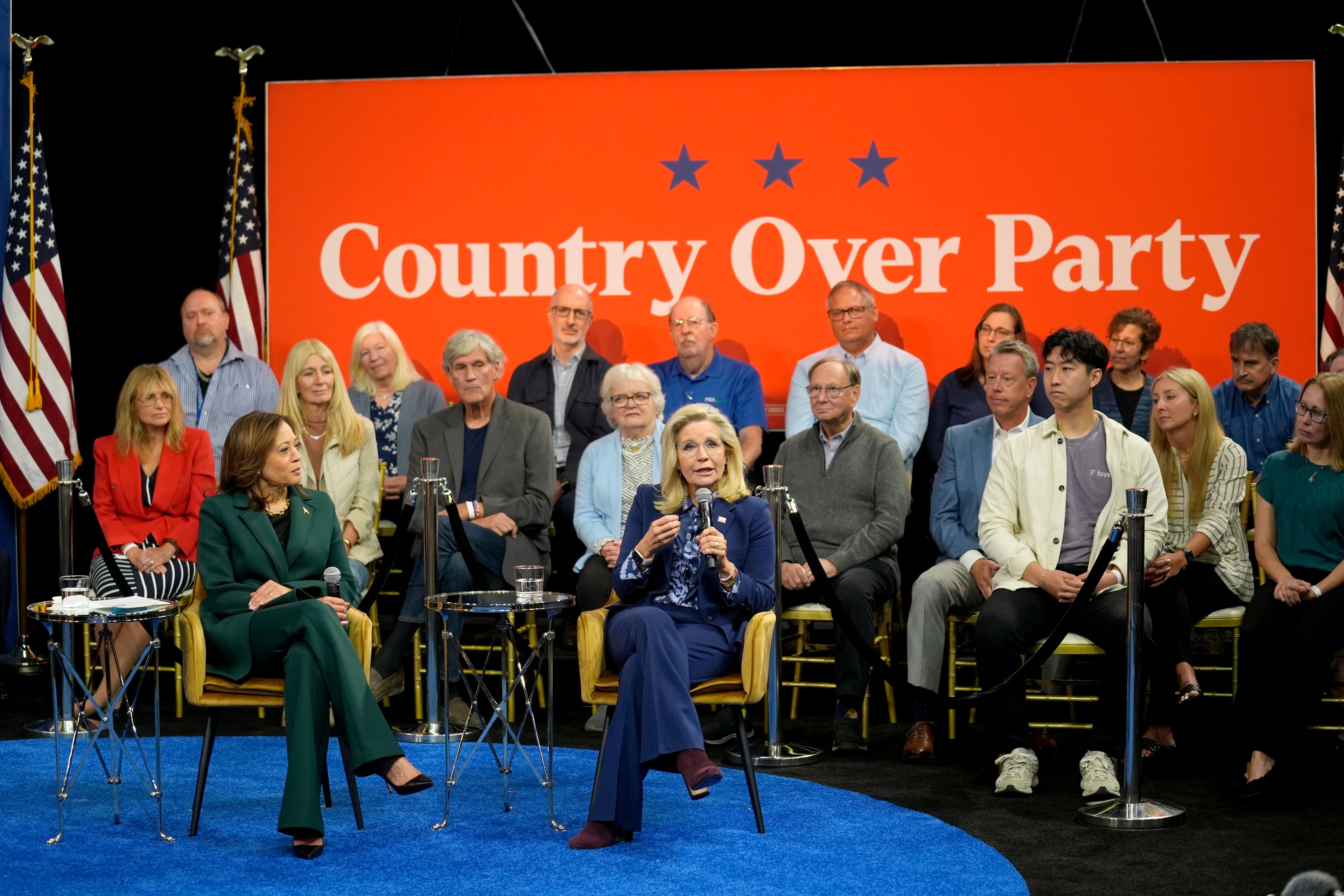 Democratic presidential nominee Vice President Kamala Harris listens as Former Republican Congresswoman Liz Cheney speaks during a town hall at The People's Light in Malvern, Pa., Monday, Oct. 21, 2024. (AP Photo/Matt Rourke)