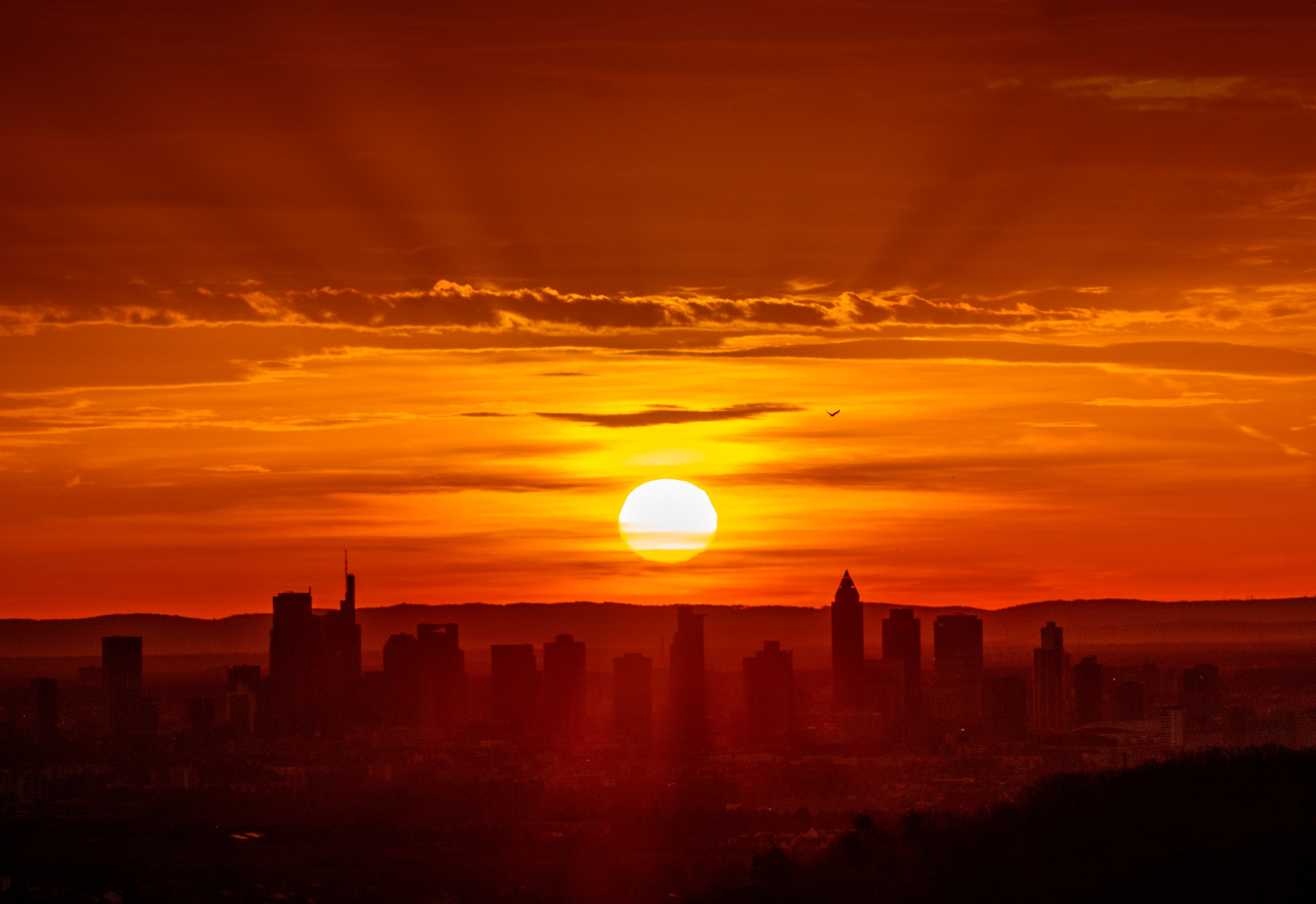 The sun rises behind buildings of the banking district in Frankfurt, Germany, Monday, Nov. 25, 2024. (AP Photo/Michael Probst)