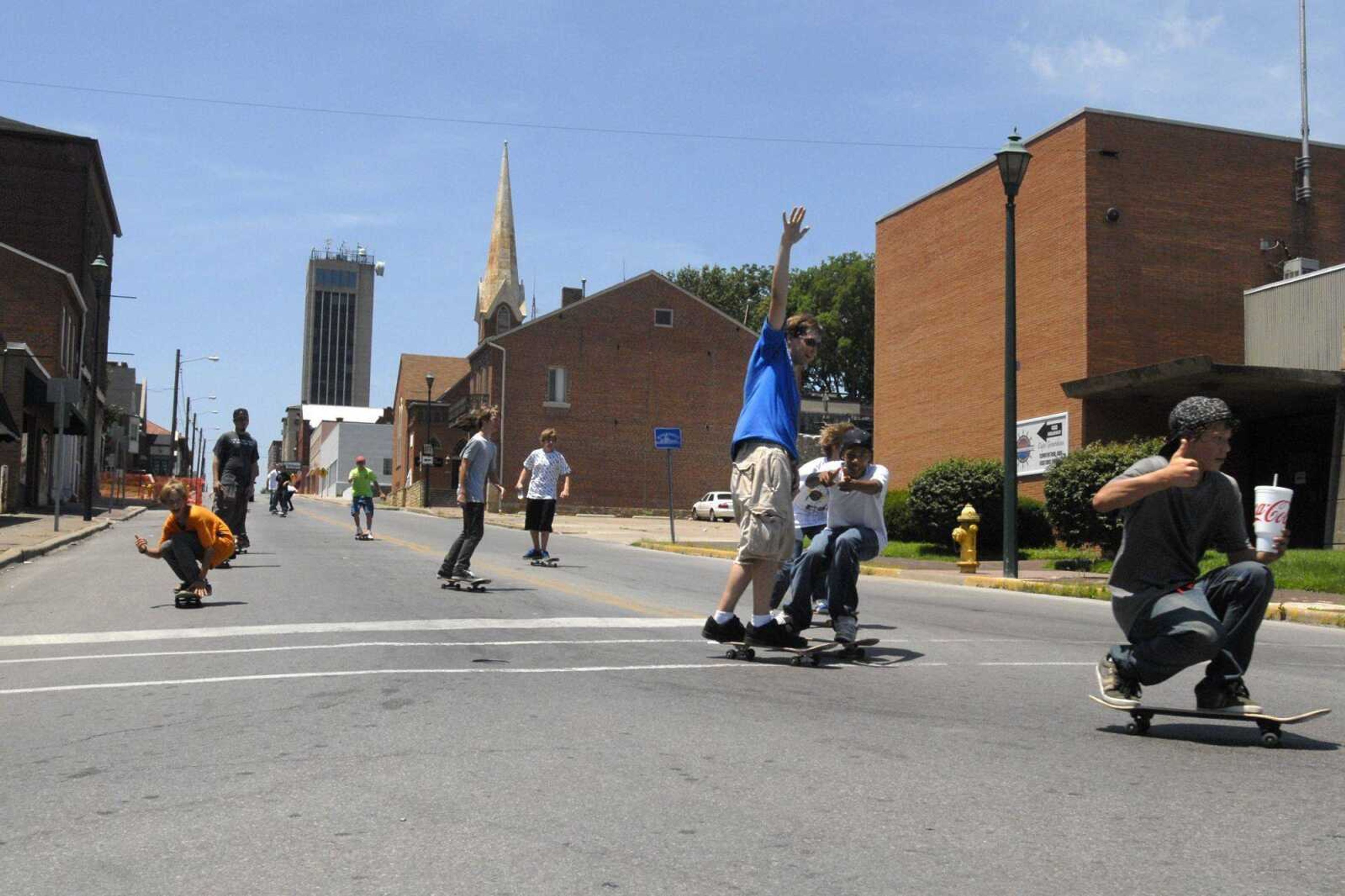 Skateboarders cruise down Broadway onto North Main Street on Sunday during a parade to Missouri Park in Cape Girardeau. (Fred Lynch)