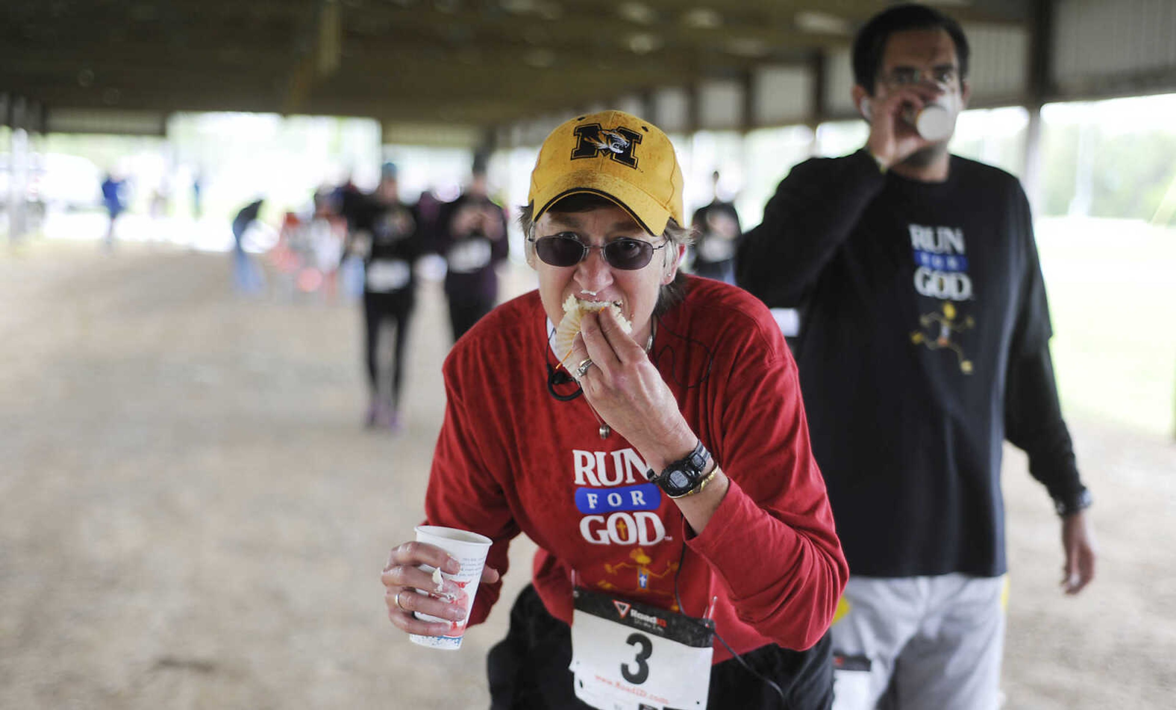 Competitors hurriedly eat a cupcakes during the 2013 Cupcake Challenge Sunday, May 5, at Arena Park in Cape Girardeau. Runners could have time deducted from their finish time for every cupcake they ate during the the 5k race, there was also a 1-mile kids race, which is a fundraiser for Hope Children's Home.