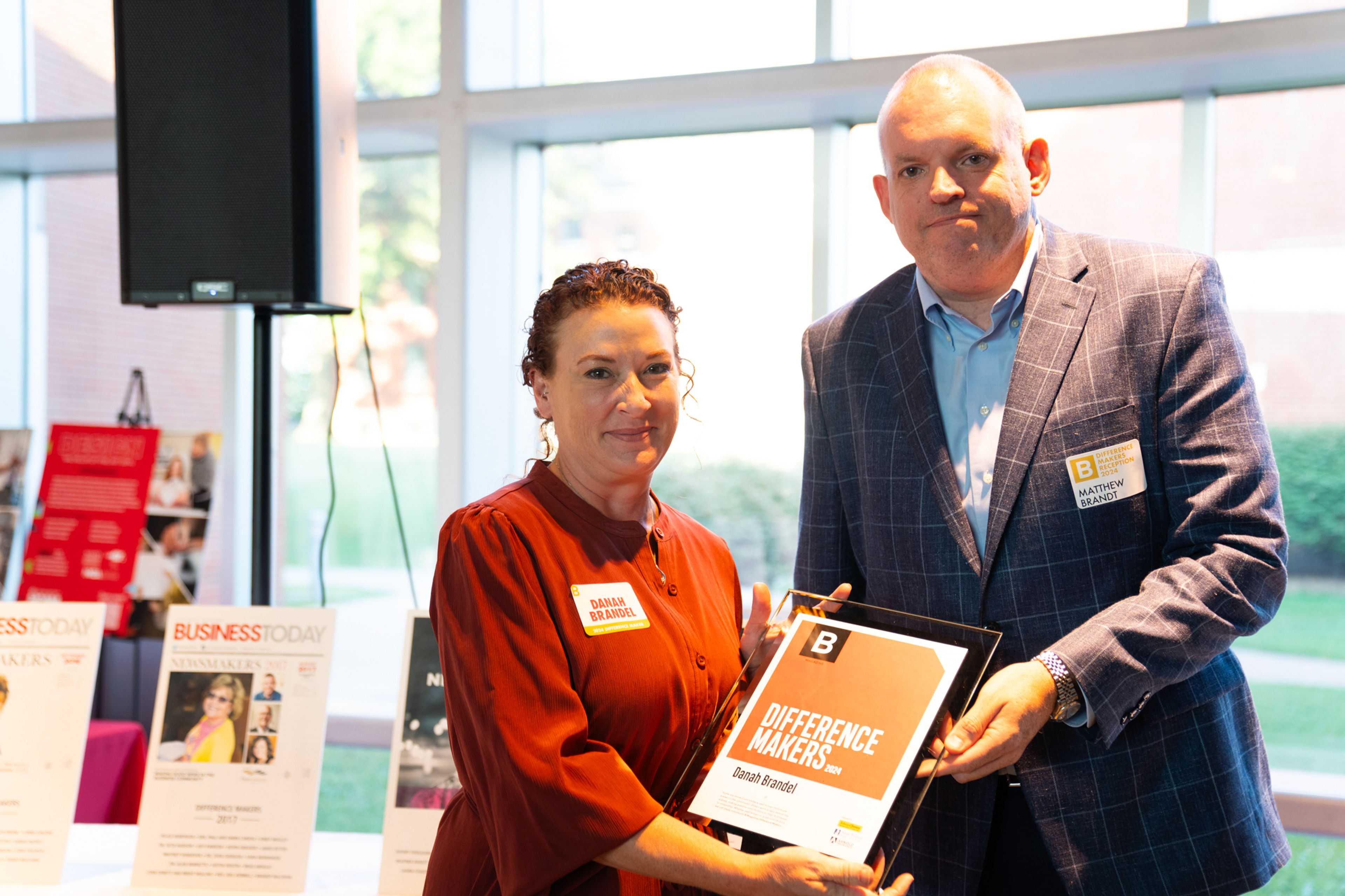 Danah Brandel receives a plaque from Saint Francis Healthcare System’s Matthew Brandt recognizing her as a 2024 Difference Maker at their reception at Southeast Missouri State University’s River Campus. The Difference Maker’s reception was presented by B Magazine on Thursday, Sept. 6.