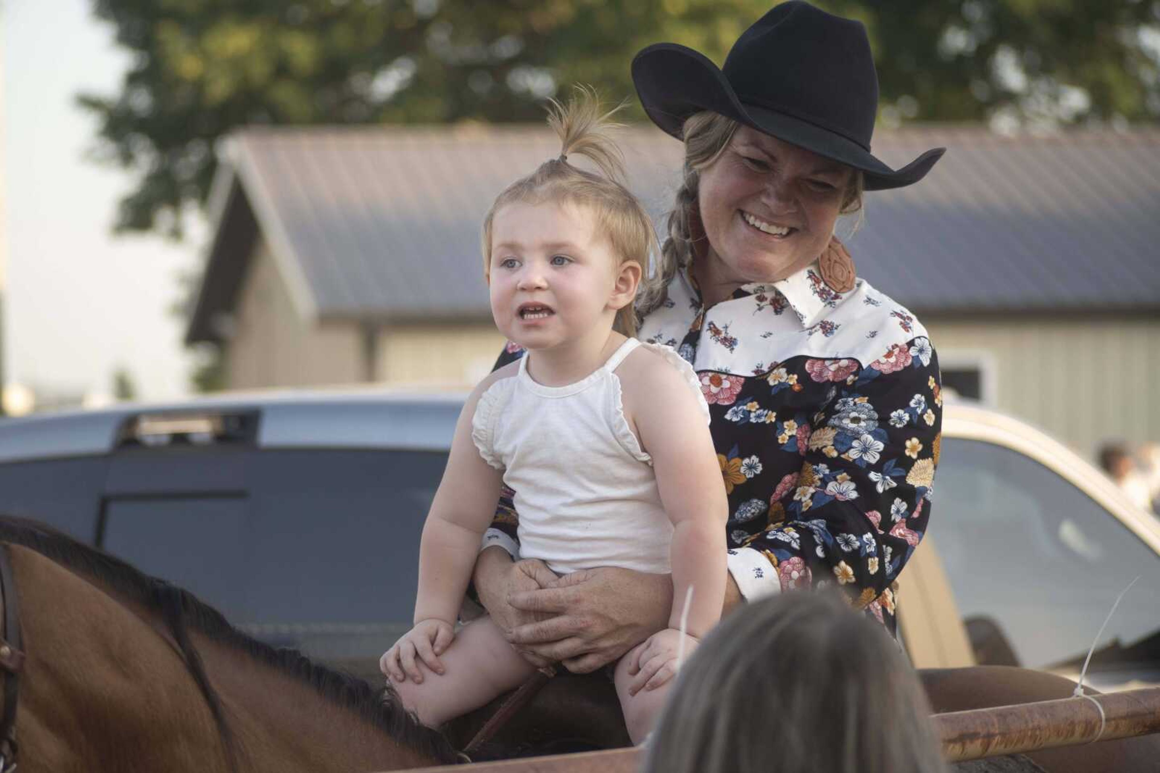 Amanda Brooks, right, holds her 2-year-old niece Ada Williams during the first night of the Sikeston Jaycee Bootheel Rodeo on Wednesday, Aug. 11, 2021, in Sikeston, Missouri.