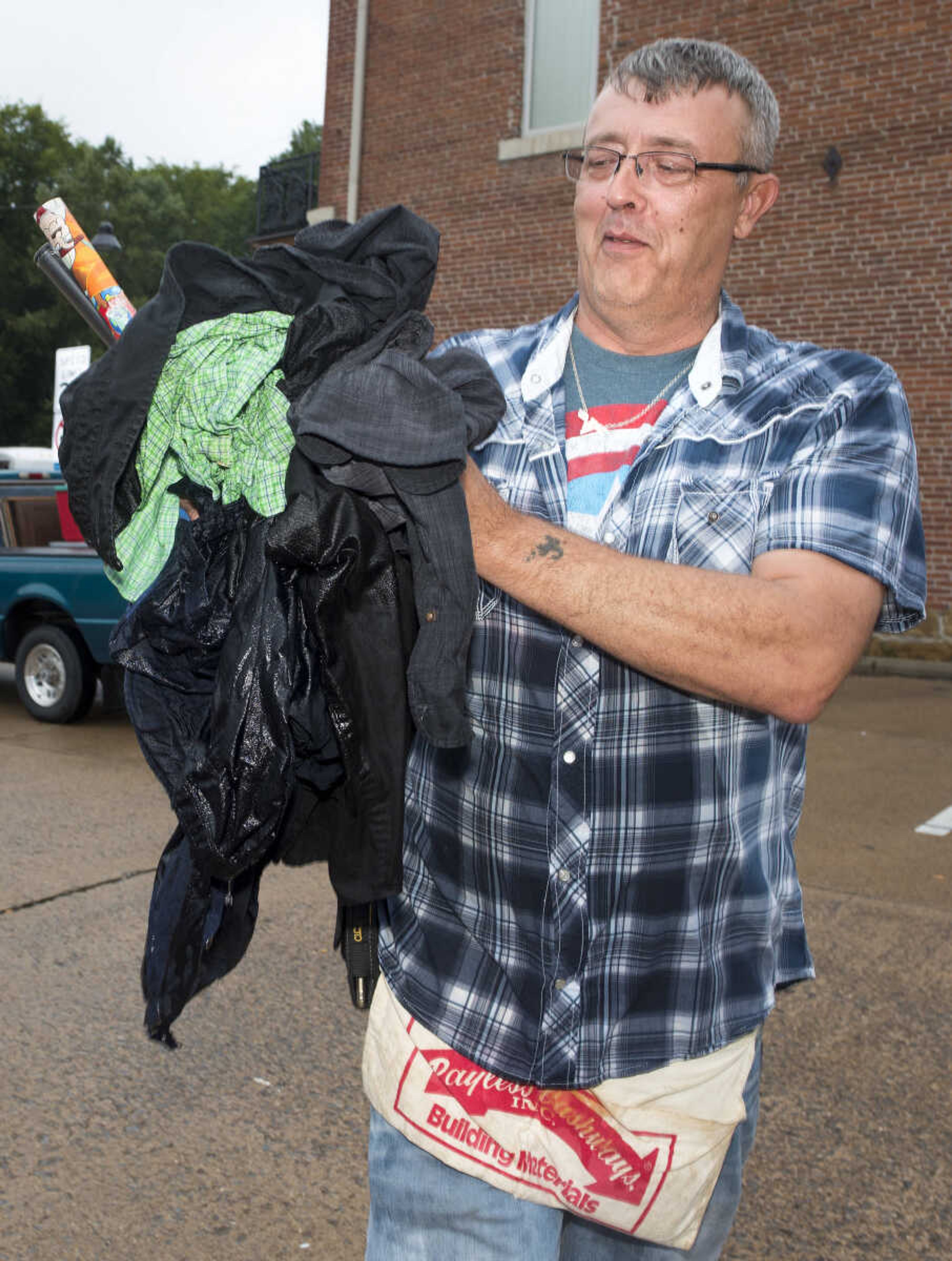 John Rogers discards a wad of water-damaged wears Sunday, Oct. 6, 2019, at the Cape Girardeau Downtown Tailgate Flea Market.