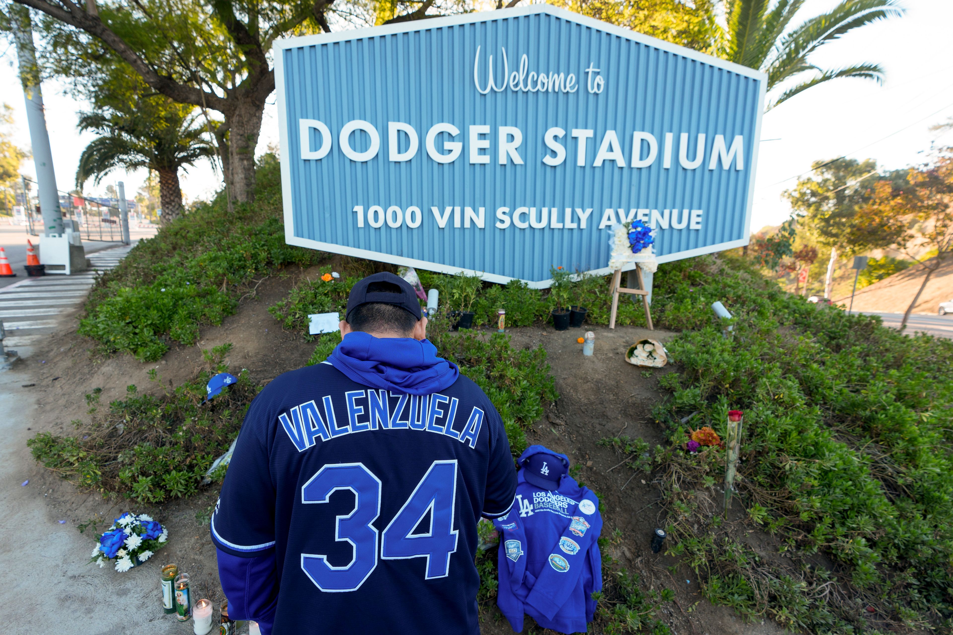 A person stands outside Dodger Stadium after the death of former Dodgers pitcher Fernando Valenzuela, Wednesday, Oct. 23, 2024, in Los Angeles. (AP Photo/Damian Dovarganes)