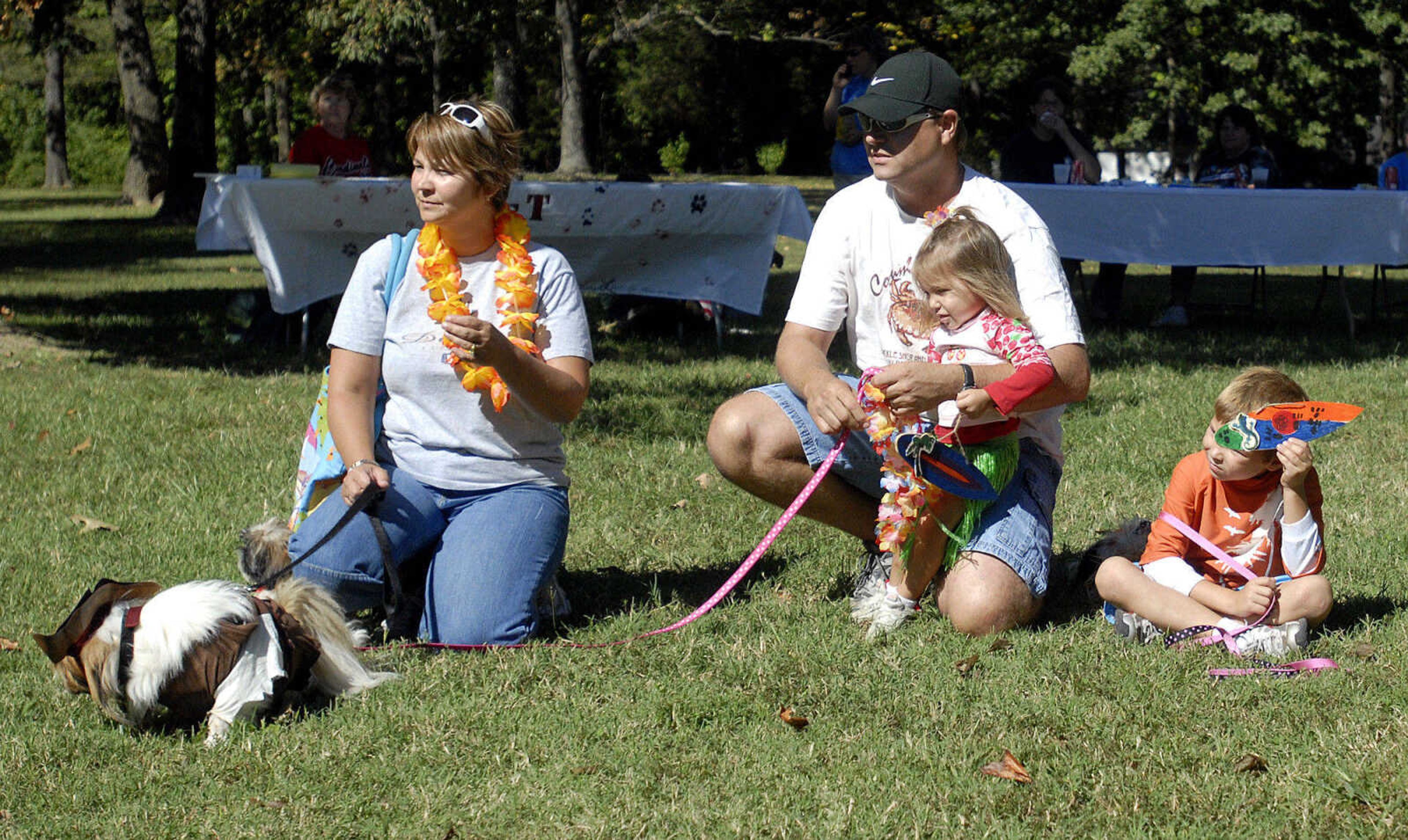 LAURA SIMON~lsimon@semissourian.com
Rhonda, Dwayne, Landyn, 2, and Logan,8, McClanahan wait for their dogs to compete in the best beach wear competition Saturday, September 25, 2010 during Bark in the Park at Kiwanis Park in Cape Girardeau.