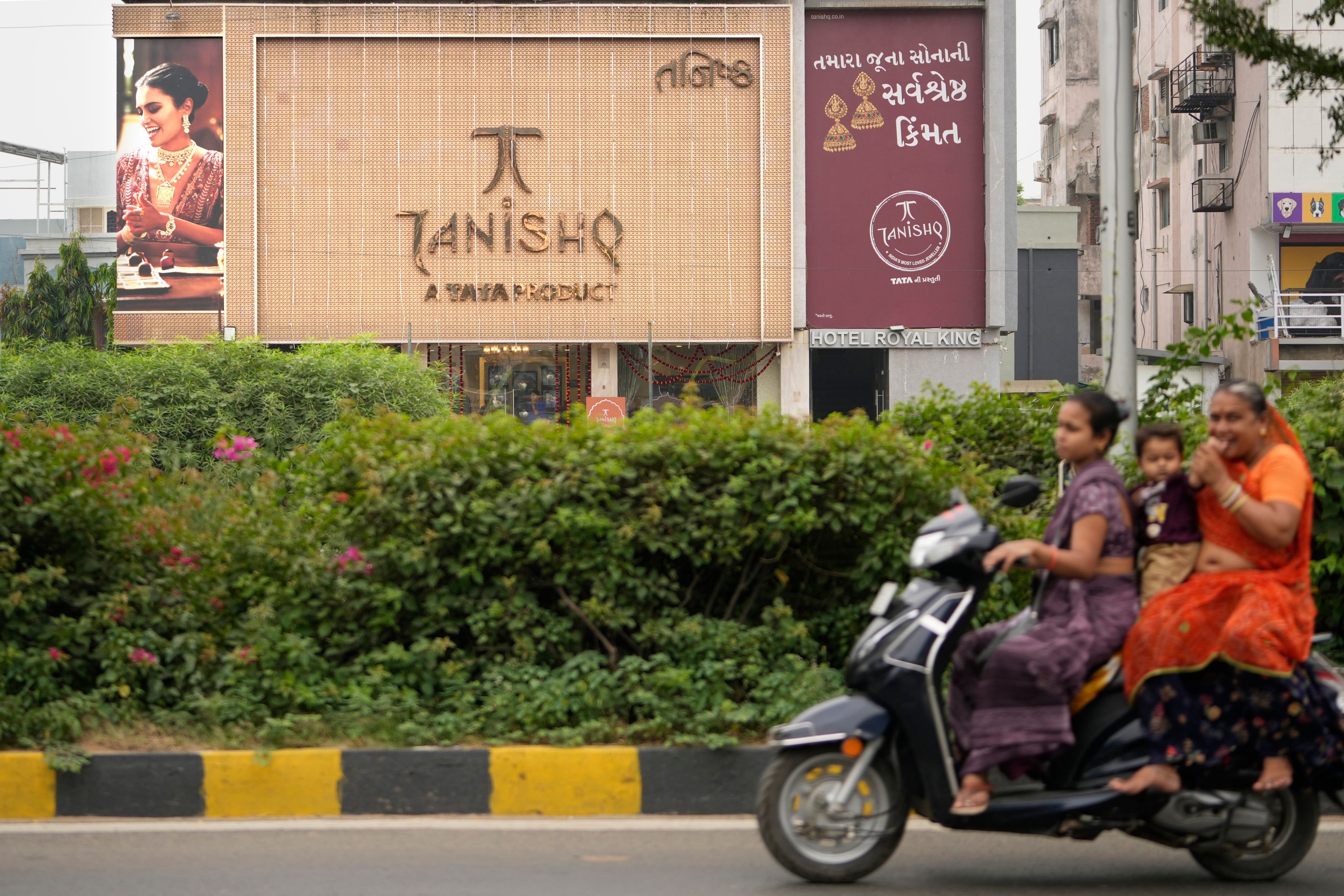 Motorists ride past a Tanishq jewelry store, a Tata group venture, in Ahmedabad, India, Thursday, Oct. 10, 2024. (AP Photo/Ajit Solanki)