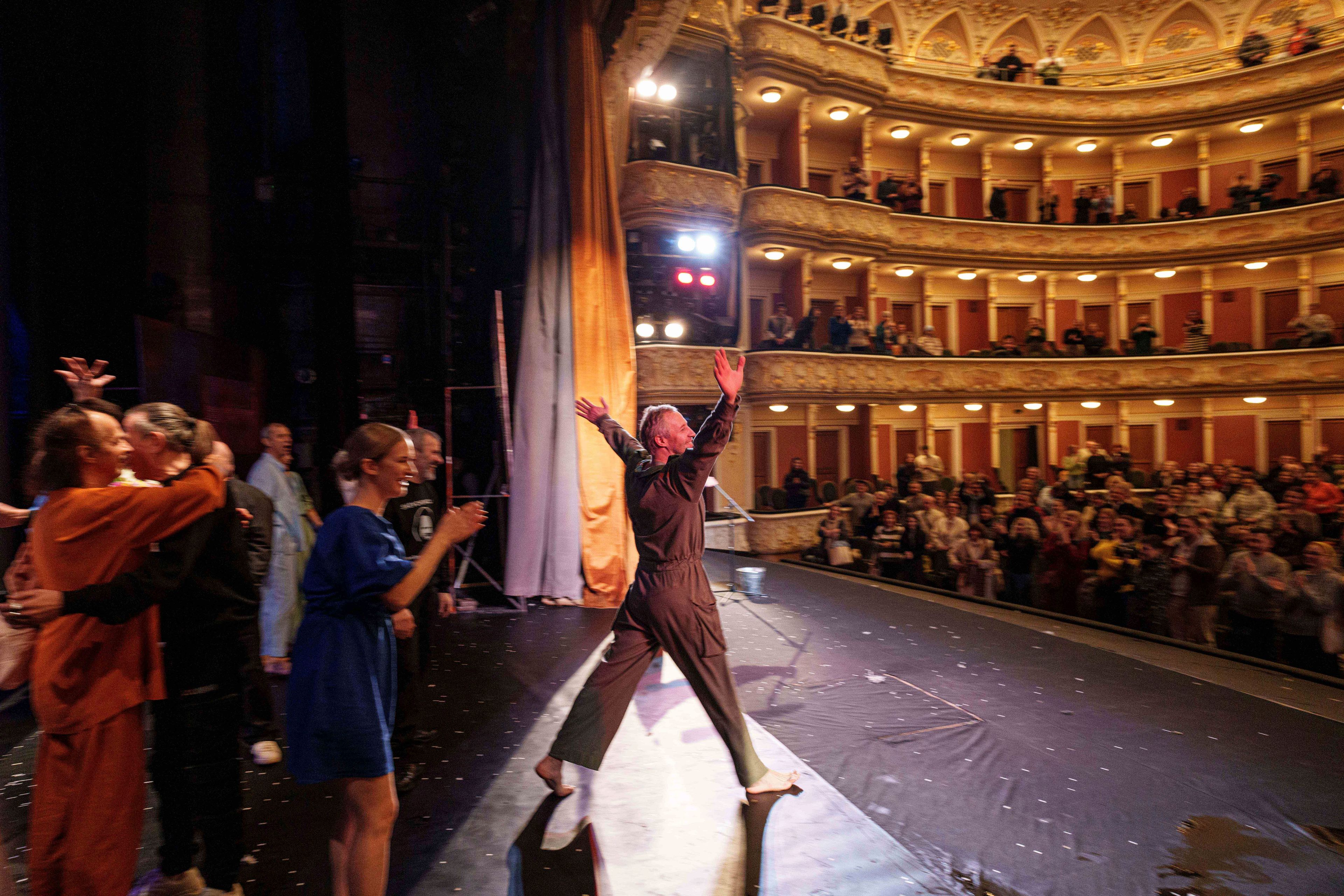 Actor Mykhailo Terschenko, second from left, acknowledges the audience at the end of the play "Shevchenko 2.0" at the Franko Theater in Kyiv, Ukraine, Nov. 11, 2024. (AP Photo/Evgeniy Maloletka)