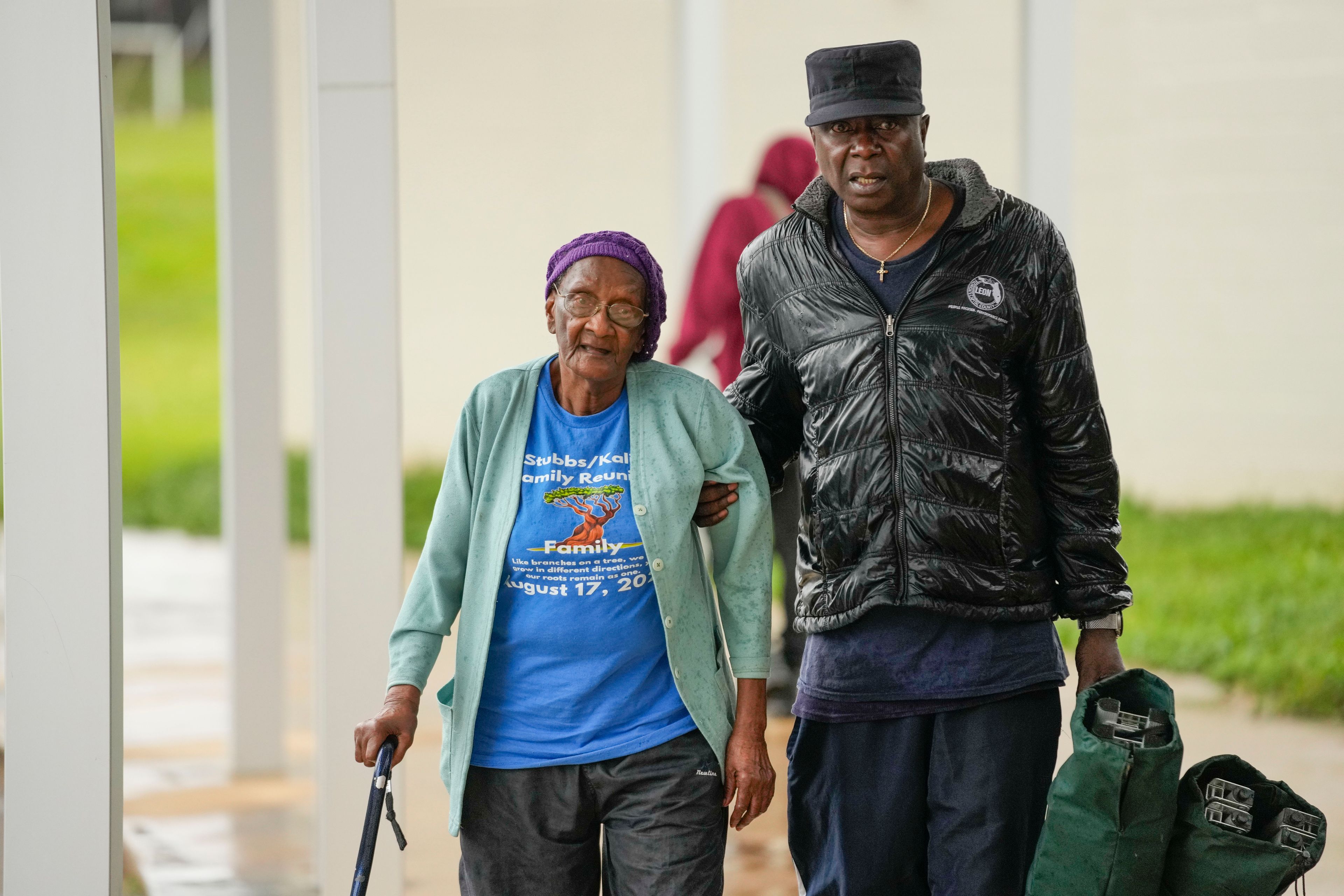 Perry Kalip and his mother Martha Kale, of Tallahassee, arrive at a a hurricane evacuation shelter at Fairview Middle School, ahead of Hurricane Helene, expected to make landfall here today, in Leon County, Fla., Thursday, Sept. 26, 2024. (AP Photo/Gerald Herbert)