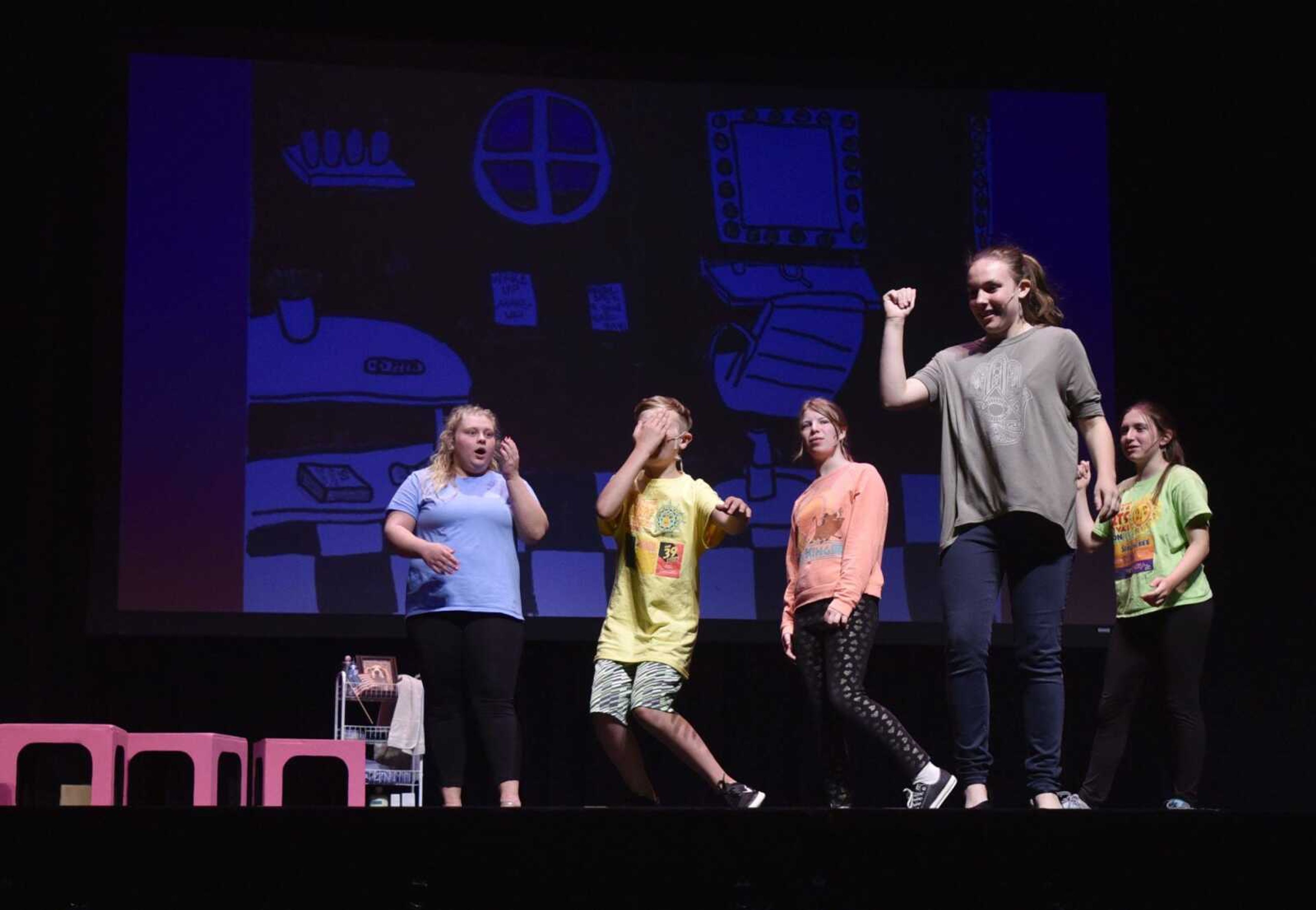 Cast members strike a pose at the closing beat of "Bend and Snap" during a "Legally Blonde Jr." rehearsal Wednesday at Bedell Performance Hall on the Southeast Missouri State University River Campus.