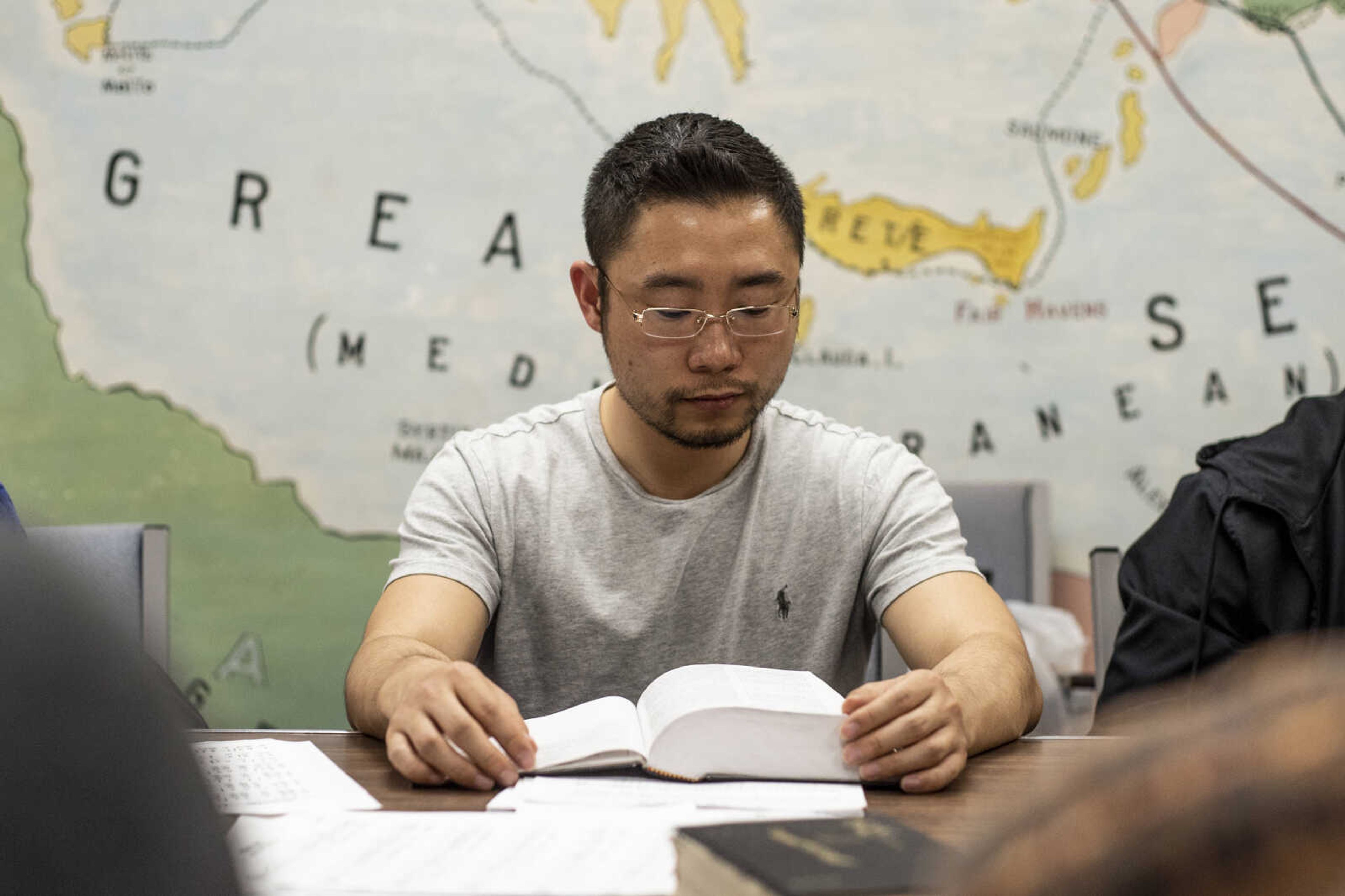 Pu (Paul) Xiao reads his Bible during the weekly Bible study Friday, March 8, 2019, at the Southeast Missouri State University Baptist Student Center in Cape Girardeau.