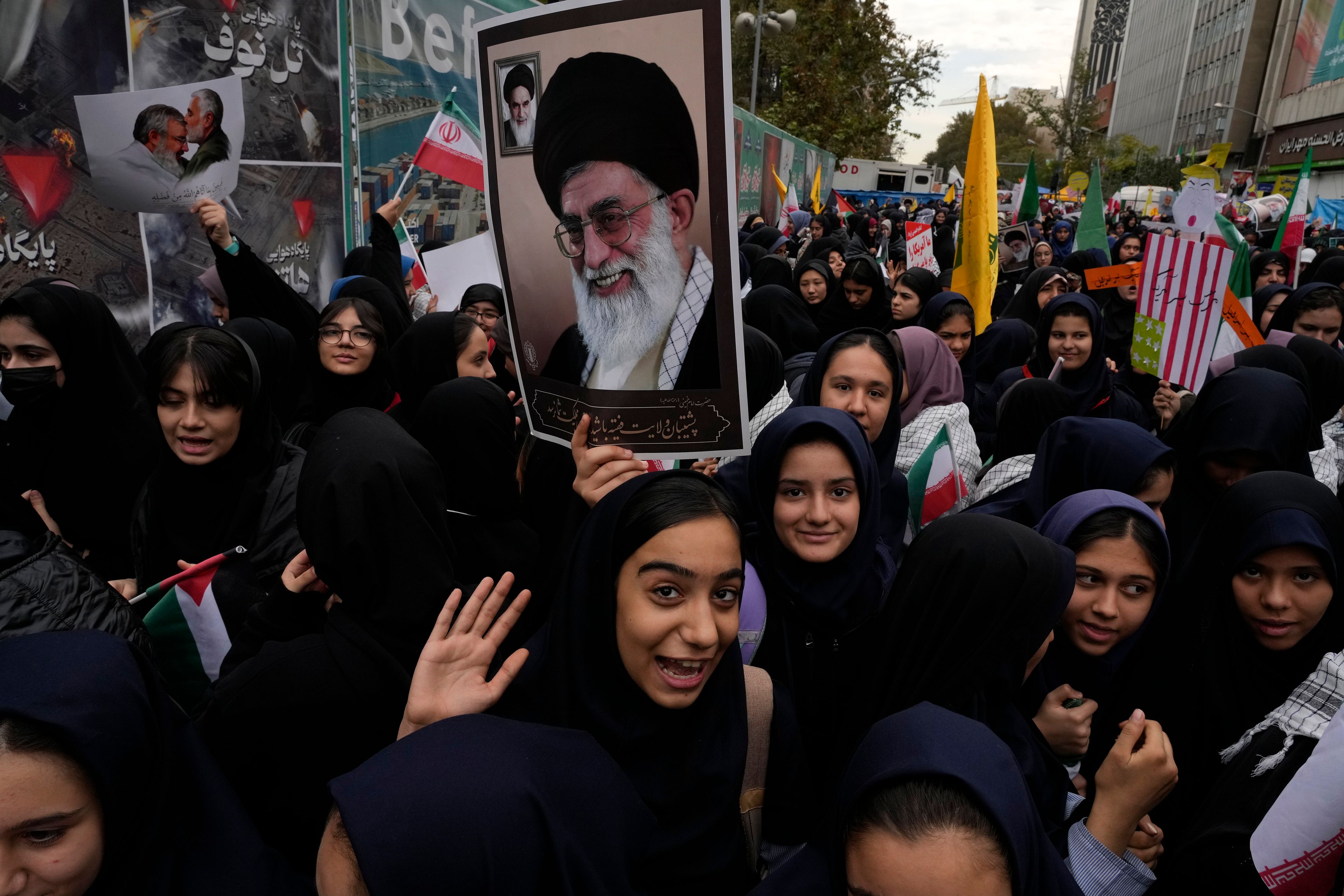 Holding a poster of the Iranian Supreme Leader Ayatollah Ali Khamenei, students attend an annual rally in front of the former U.S. Embassy in Tehran, Iran, Sunday, Nov. 3, 2024, marking the 45th anniversary of Iranian students' takeover of the embassy, starting a hostage crisis. (AP Photo/Vahid Salemi)