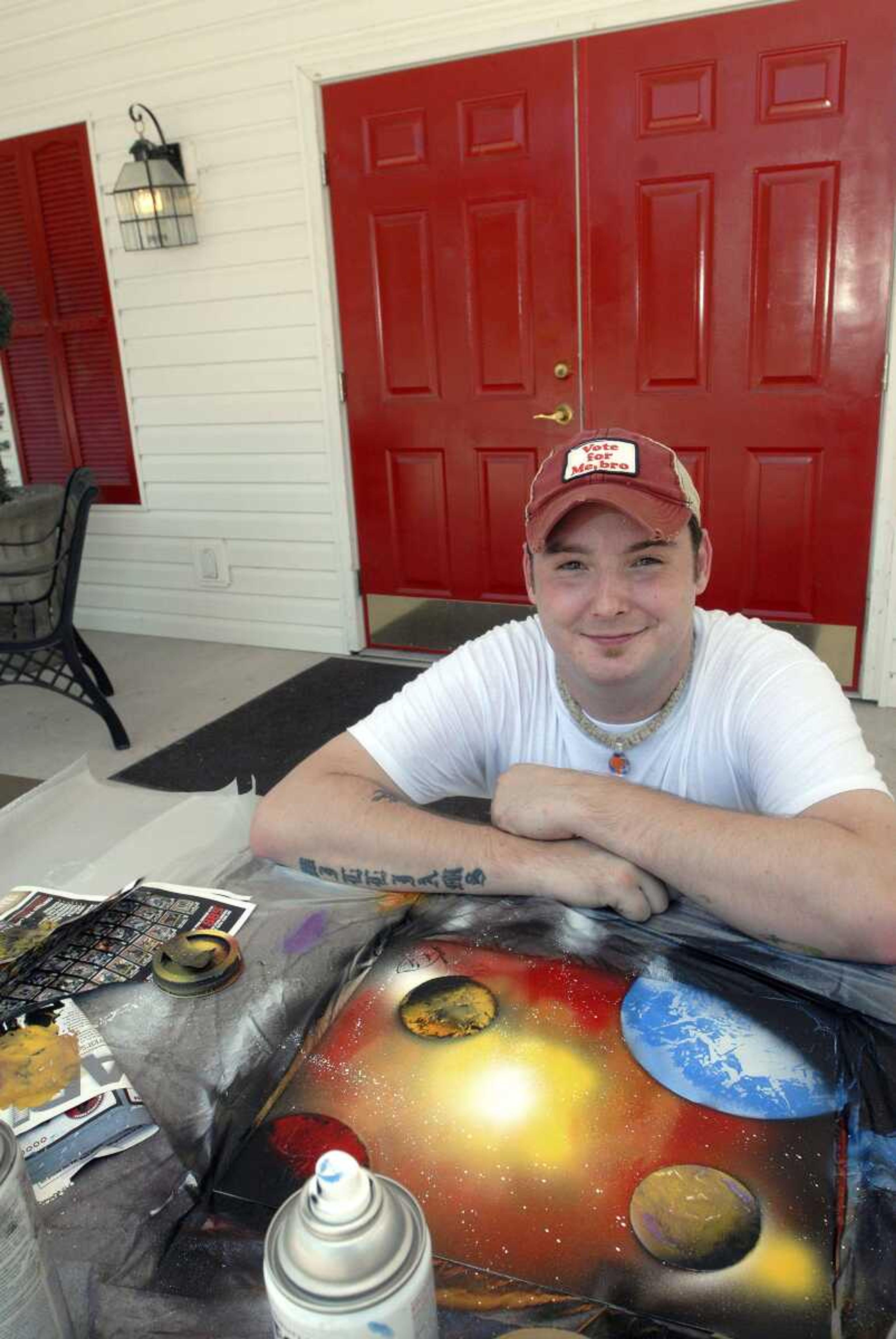 Spray paint artist Travis Williams creates an original work of art Wednesday outside Aartful Rose in Cape Girardeau. (Laura Simon)