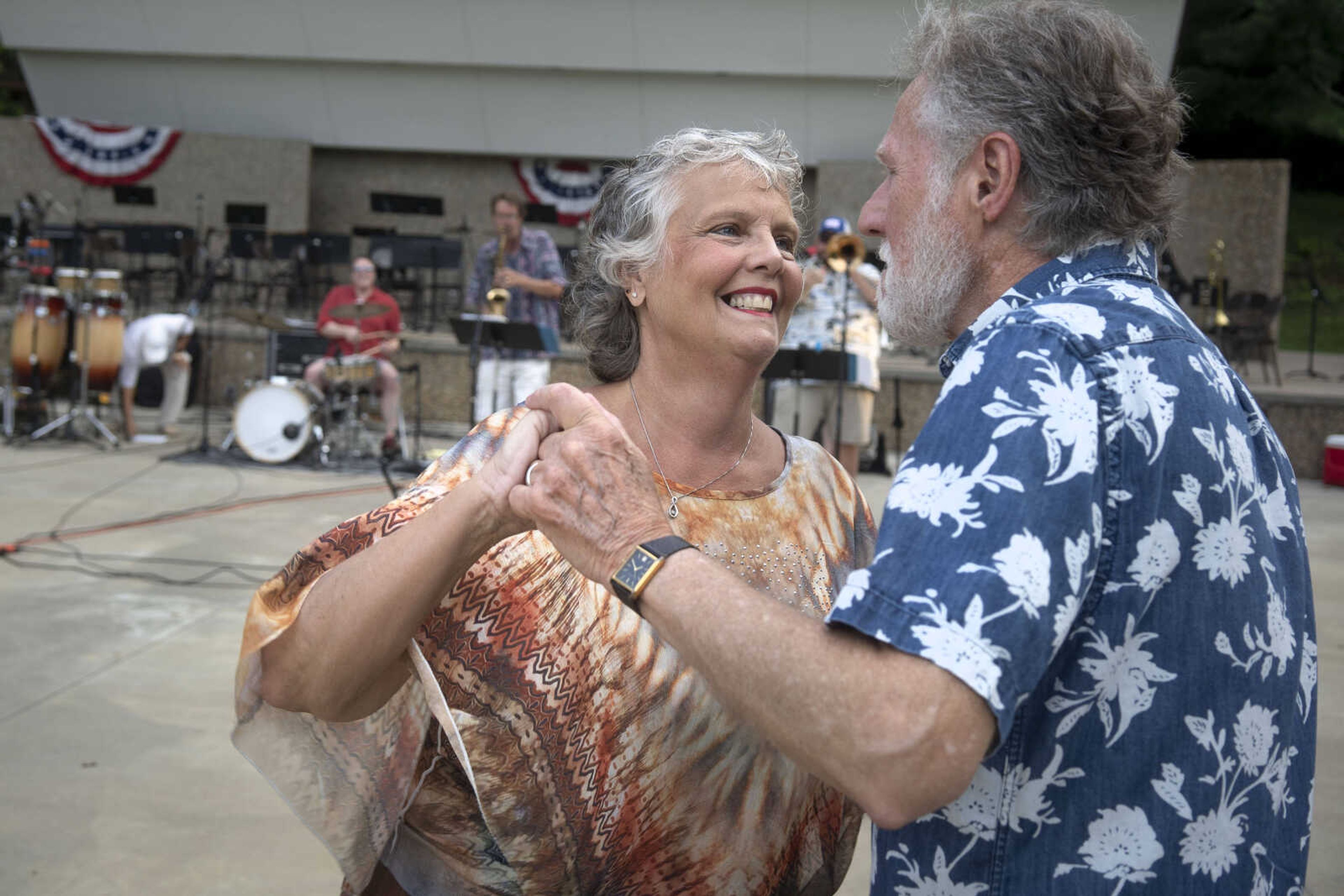 Karen Stroder smiles while dancing with her husband, Gary, during an Independence Day celebration at the Jackson Municipal Band Shell.