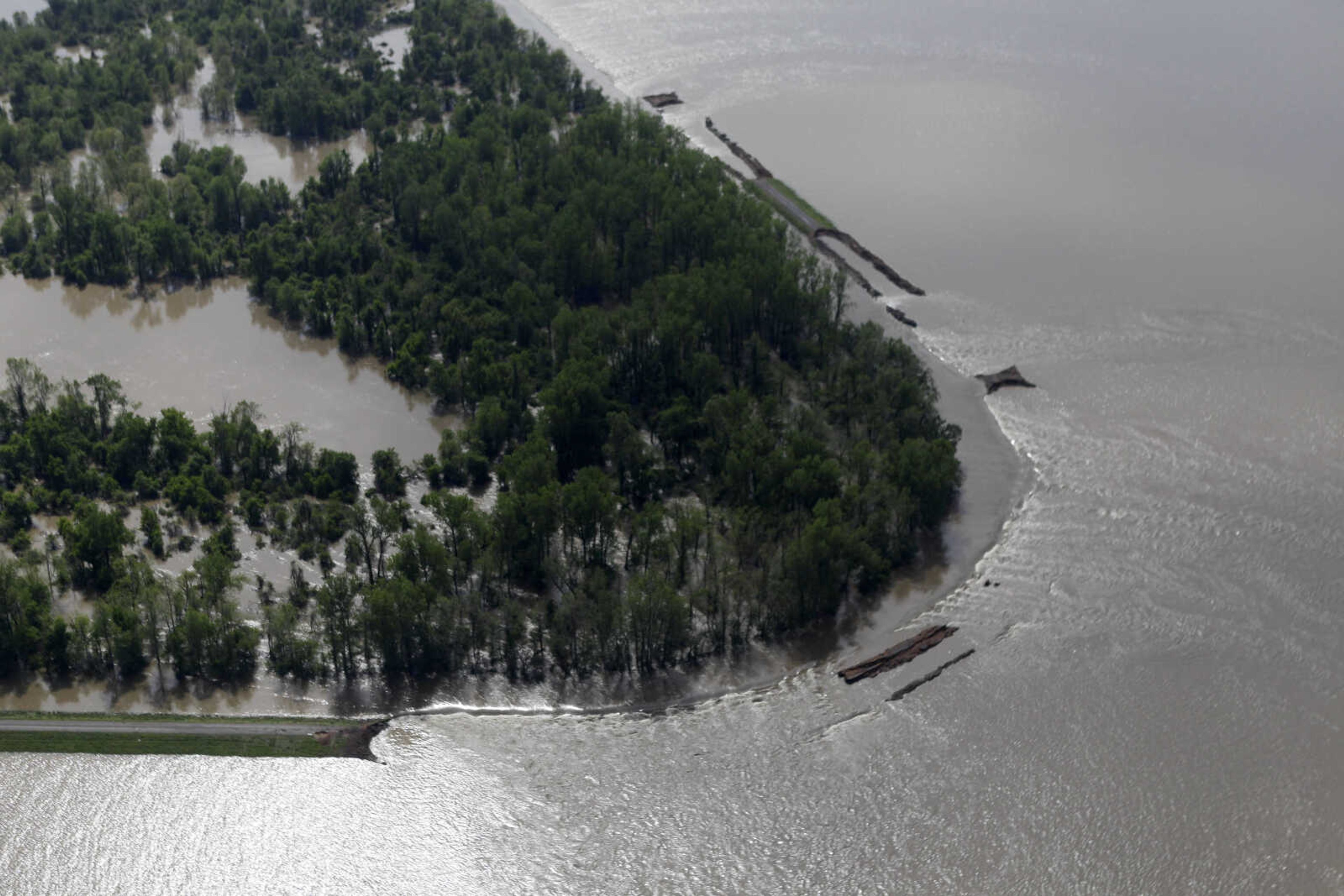 Water flows through an intentional breech in the Birds Point levee Tuesday, May 3, 2011, in Mississippi County, Mo.  Army Corps of Engineers' blew a two-mile hole Monday night into the Birds Point levee in southeast Missouri, which has flooded 130,000 acres of farmland in Missouri's Mississippi County in an effort to protect nearby Cairo, Ill. from rising floodwaters. (AP Photo/Jeff Roberson)