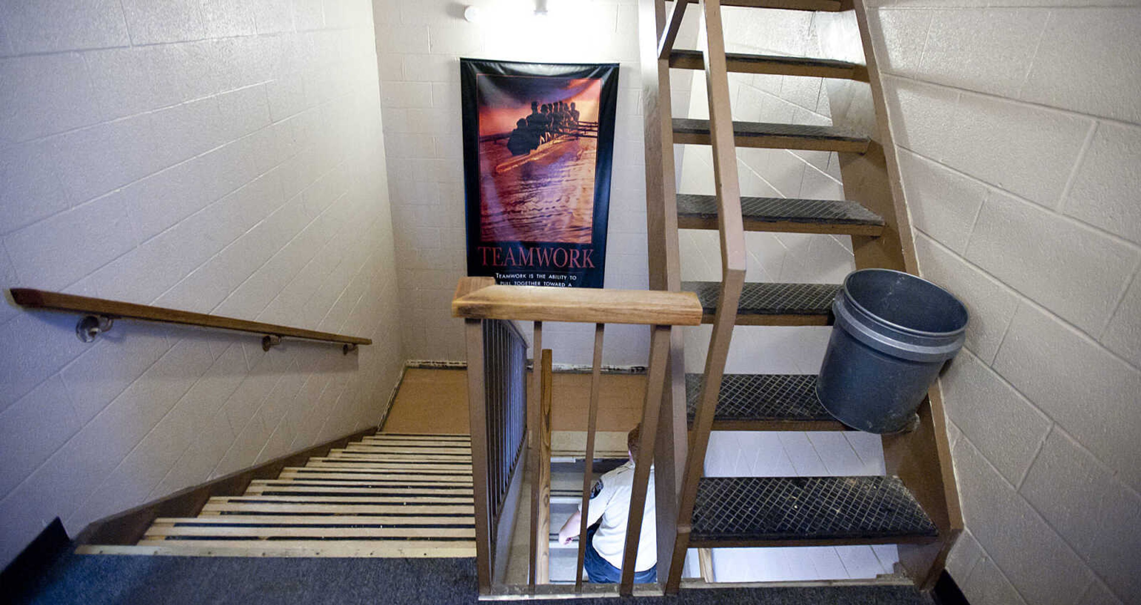 A bucket sits on a staircase during a tour of the Cape Girardeau Police Department Friday, March 14, in Cape Girardeau. The tour was part of an open house held by the police department to show the public the problems with the current headquarters building. The building is plagued by leaks and a lack of space for personnel and storage.