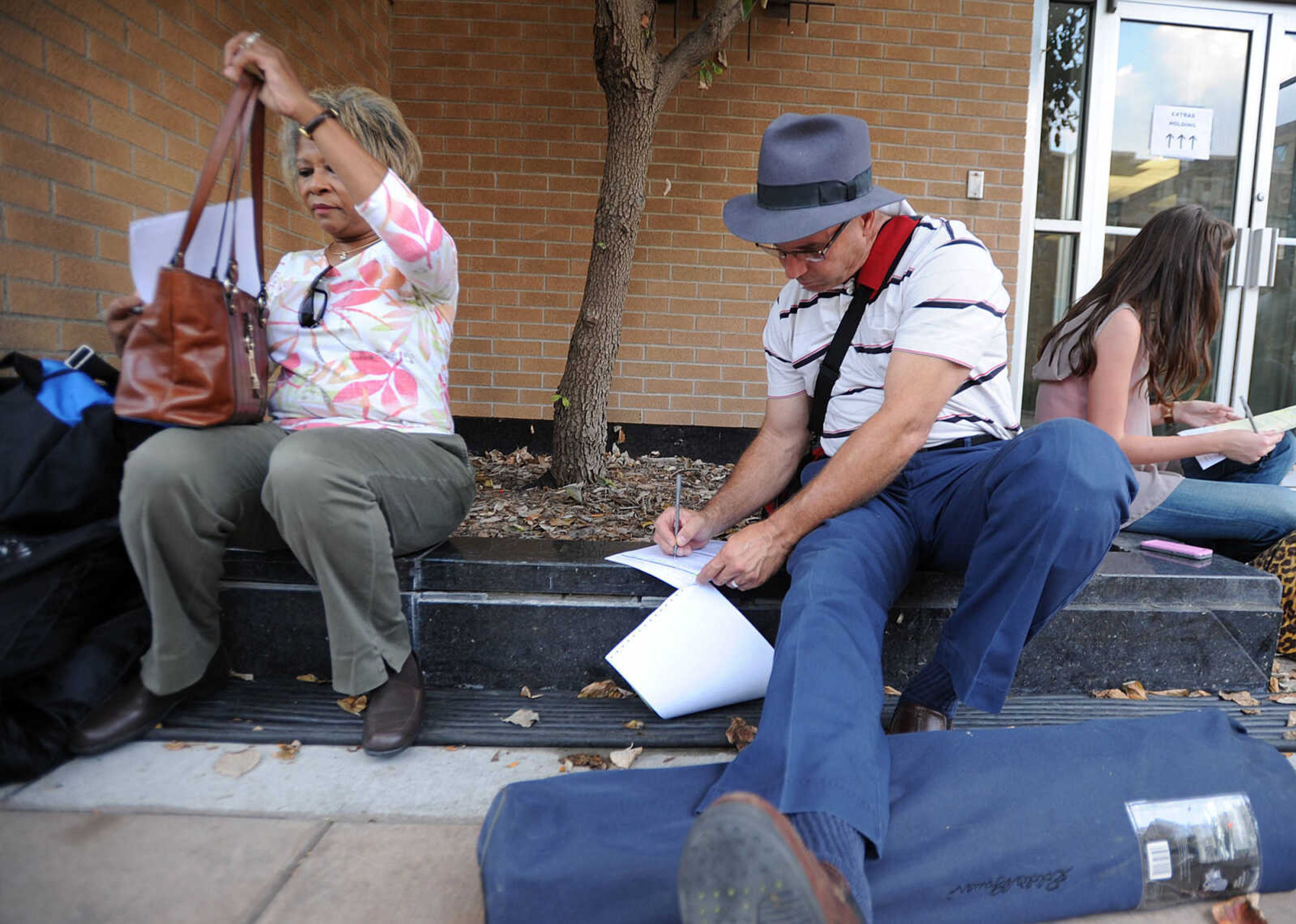 LAURA SIMON ~ lsimon@semissourian.com

Fay Powders of Cape Girardeau, and Larry Essner of Benton, Mo. fill out their paperwork to be extras in 20th Century Fox's feature film "Gone Girl", Thursday, Oct. 3, 2013, in Cape Girardeau.