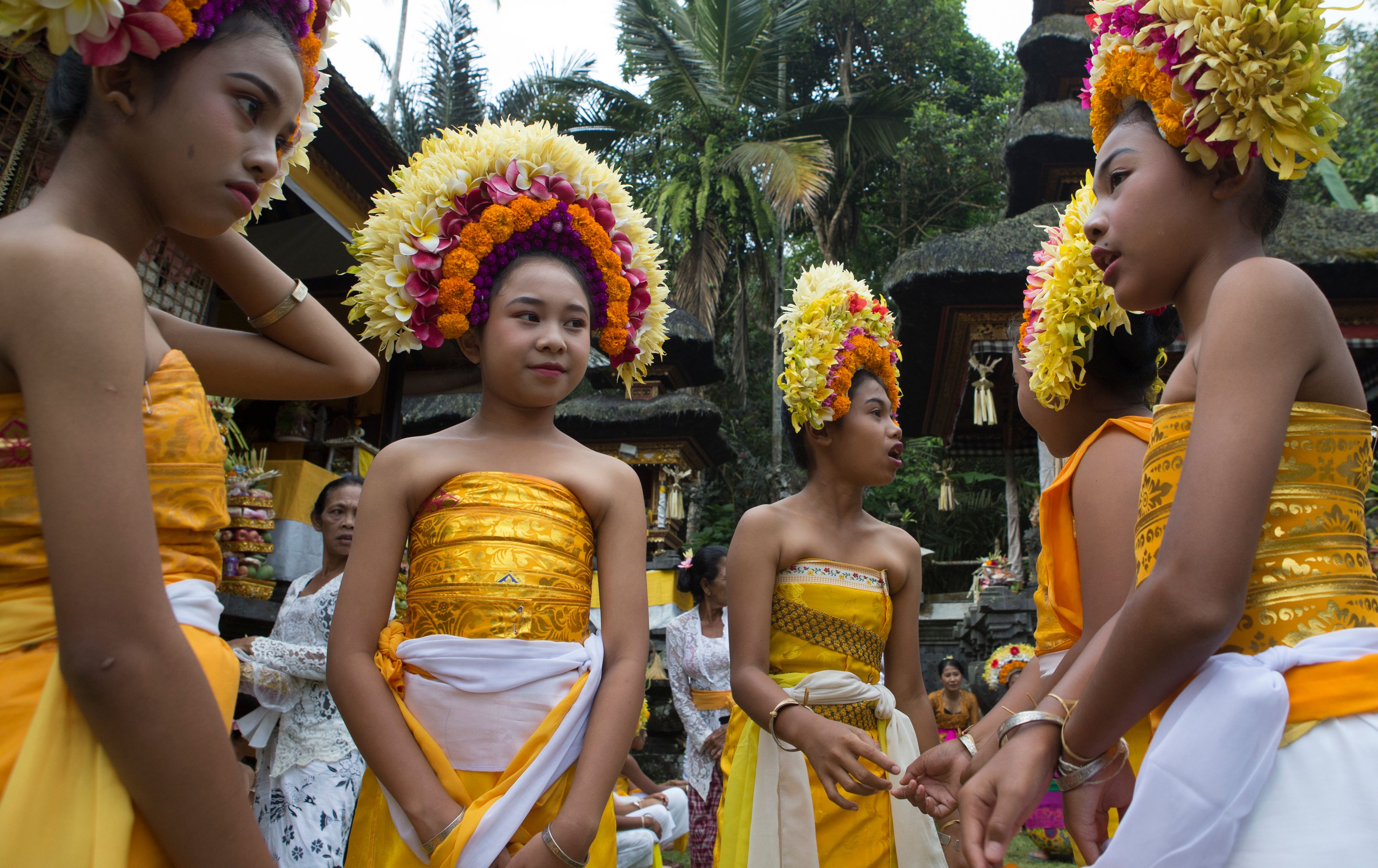 Ketut Nita Wahyuni, second left, stands with her friends as they participate in Rejang Pucuk in at Geriana Kauh village, Karangasem, Bali, Indonesia, Thursday, Nov. 21, 2024. (AP Photo/Firdia Lisnawati)