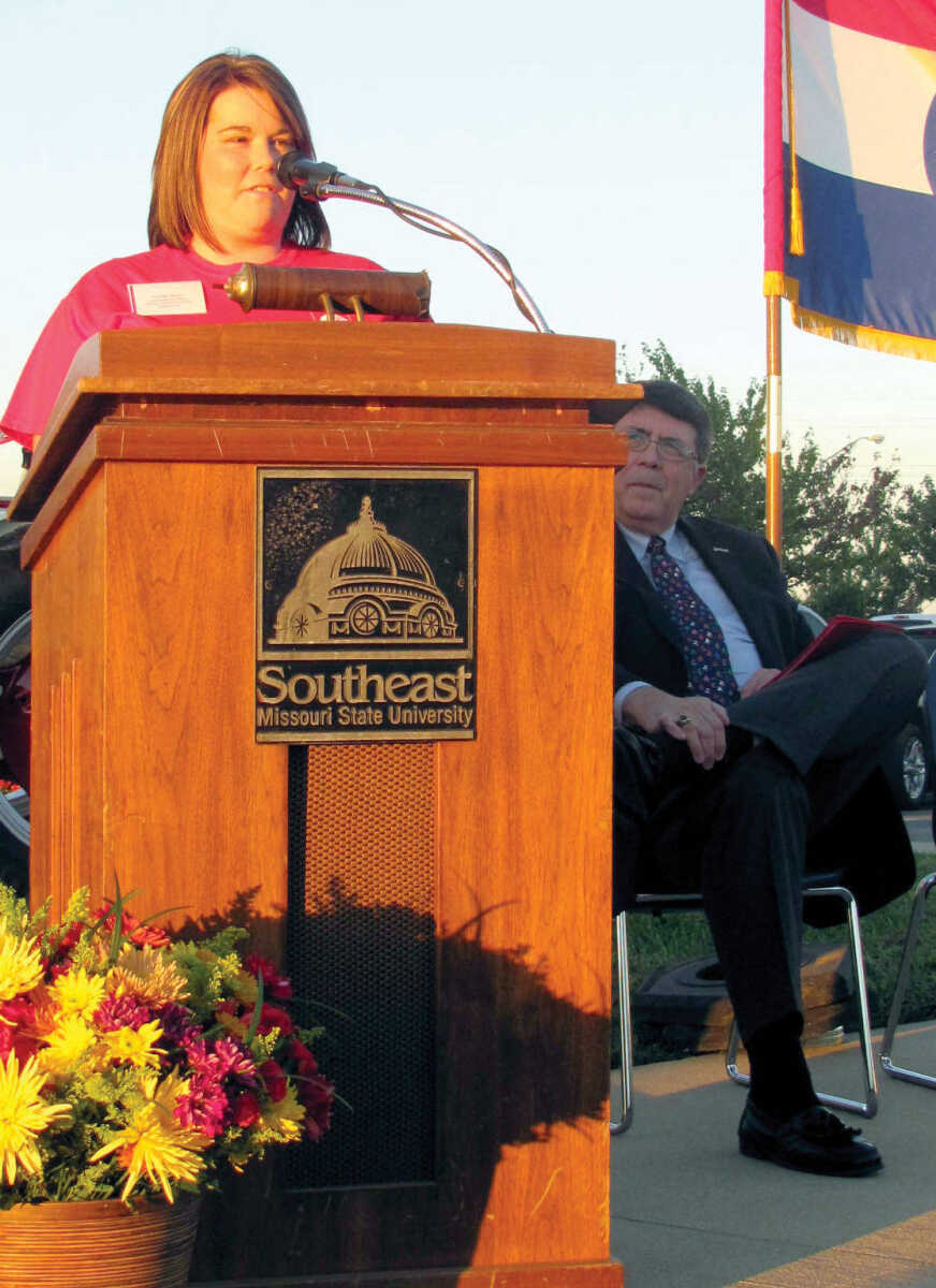 Jordon Reno, a student in Southeast Missouri State University-Sikeston's new four-year agribusiness program, speaks during a fish fry and ribbon cutting held Thursday. Looking on is University President Dr. Ken Dobbins. (Michelle Felter/Standard Democrat)