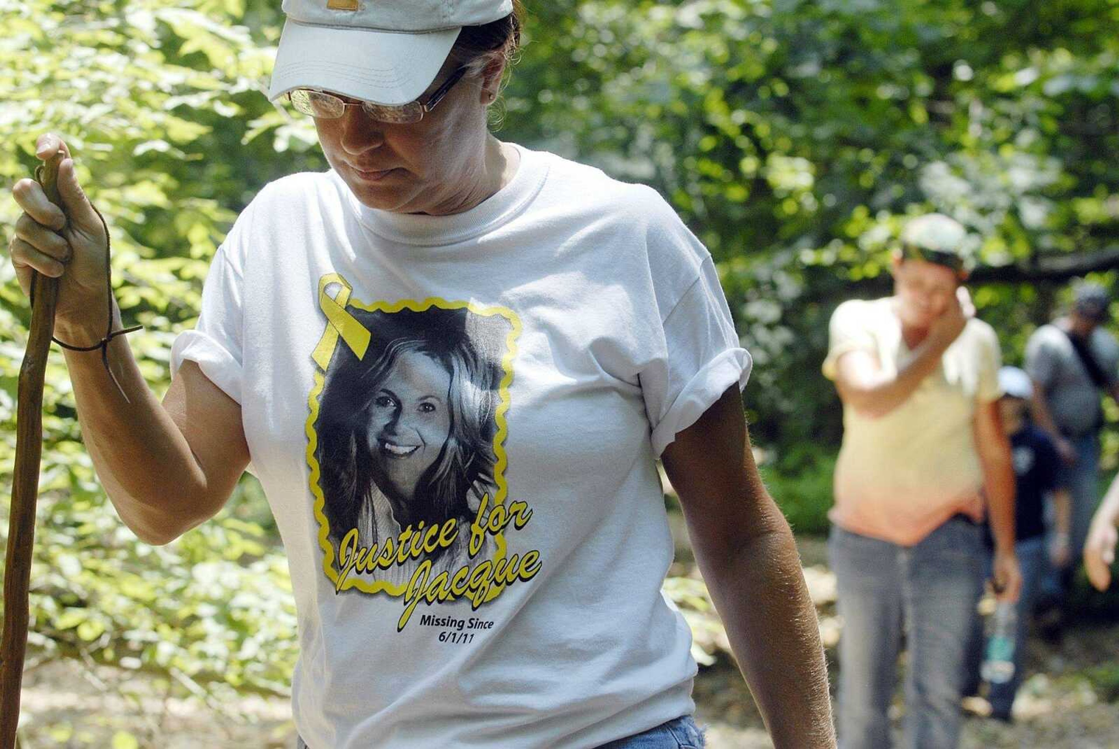 Paula Martin of Jackson hikes through a wooded area northeast of Cape Girardeau Sunday, June 26, 2011 in search of her friend Jacque Waller. Around 30 friends and family members led the search for Waller who has been missing since June 1. (Laura Simon)