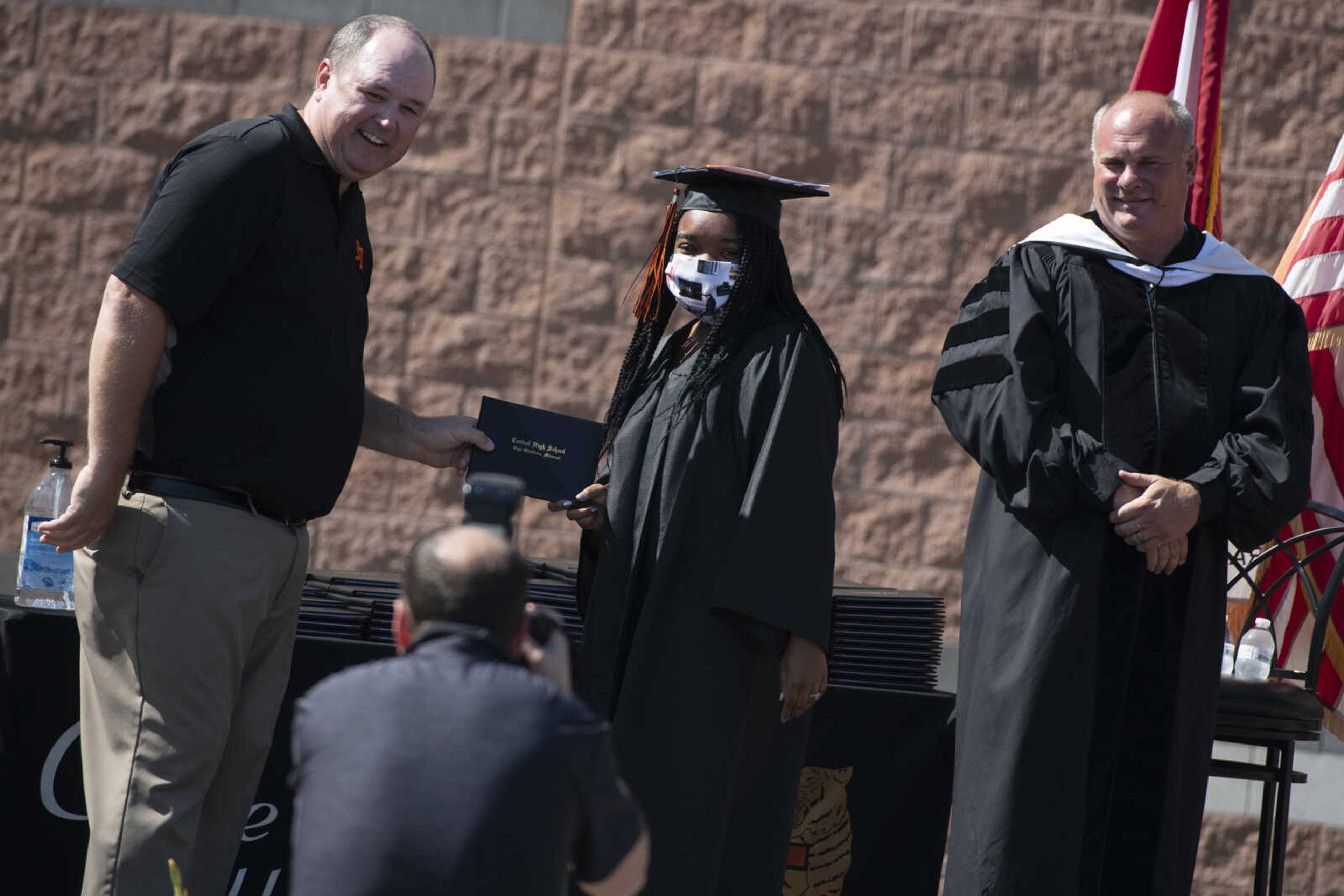 Graduate Anita Kellum meets with Jeff Glenn, former board of directors president for the Cape Girardeau School District (left), and Cape Girardeau School District superintendent Neil Glass (right) during a drive-through graduation ceremony Saturday, June 13, 2020, at Cape Girardeau Central High School in Cape Girardeau.&nbsp;