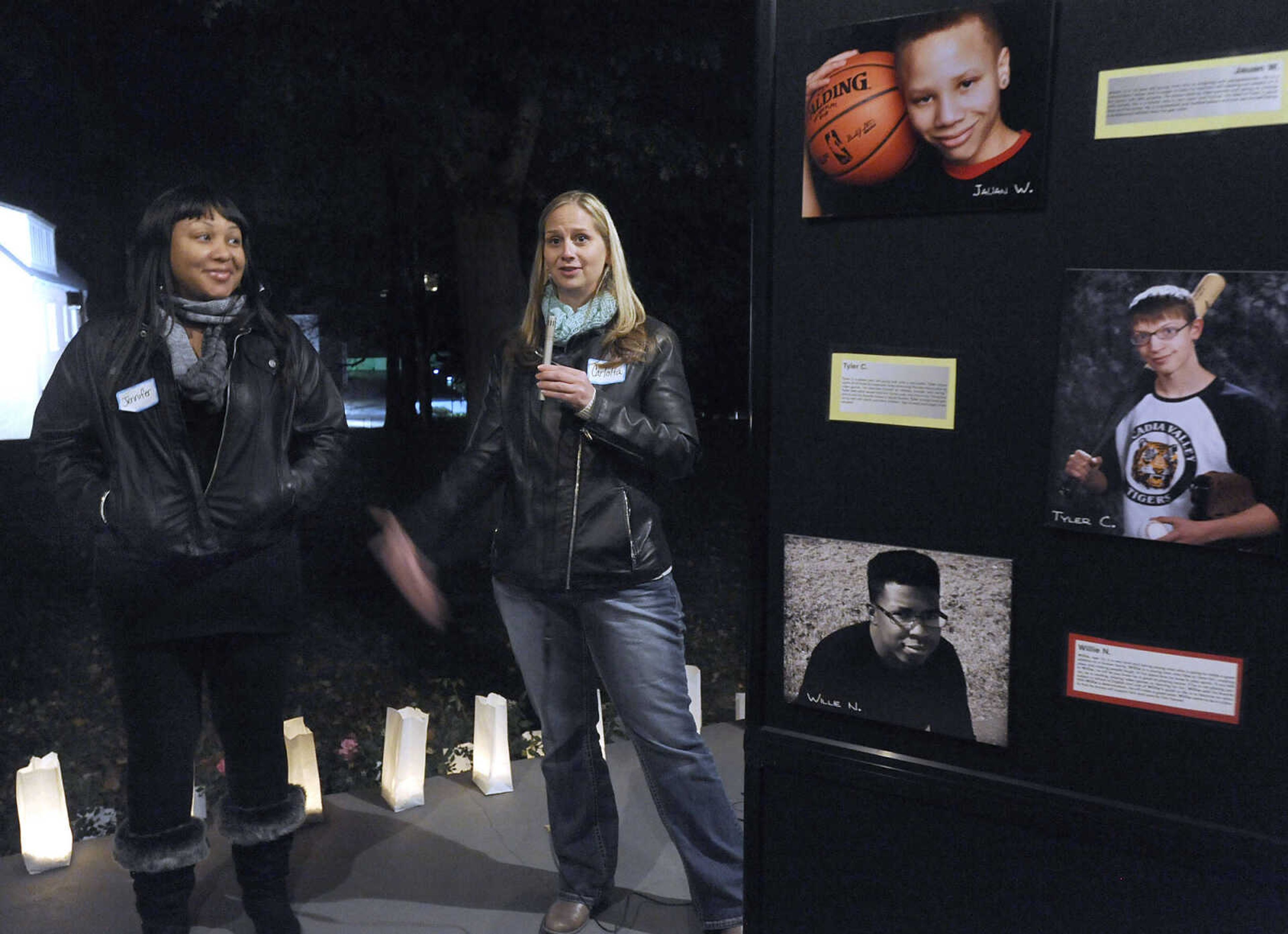 FRED LYNCH ~ flynch@semissourian.com
Jennifer Jones, left, a foster parent who is in the adoption process, listens as Carlotta Warmack, adoption specialist with the Missouri Children's Division, speaks during the Orphan Sunday Candlelight Vigil at Common Pleas Courthouse gazebo Sunday, Nov. 2, 2014 in Cape Girardeau. The Missouri Heart Gallery of children available for adoption through the state foster care system was on display.