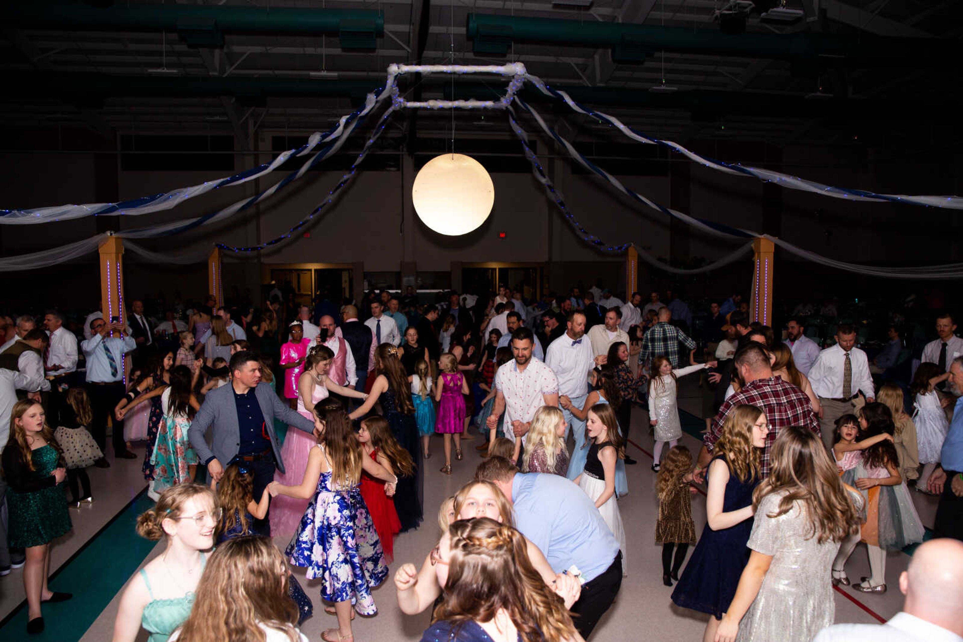 Fathers and their daughters dance together at the 15th annual "I love you to the moon and back" Father Daughter Dance on Saturday, Feb. 18 at the Osage Center.