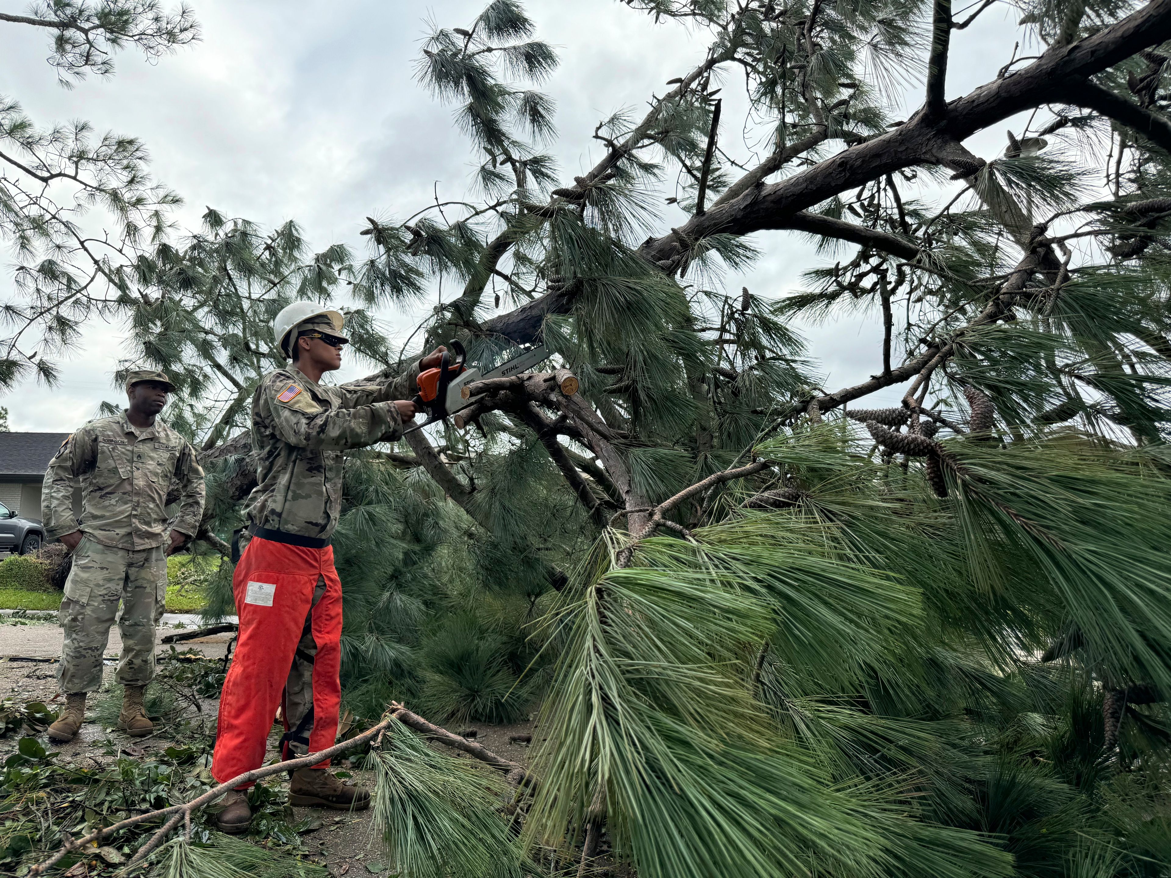 National Guardsmen clear trees after arriving in Morgan City, La., on Thursday, Sept. 12, 2024 after Hurricane Francine. (AP Photo/Jack Brook)