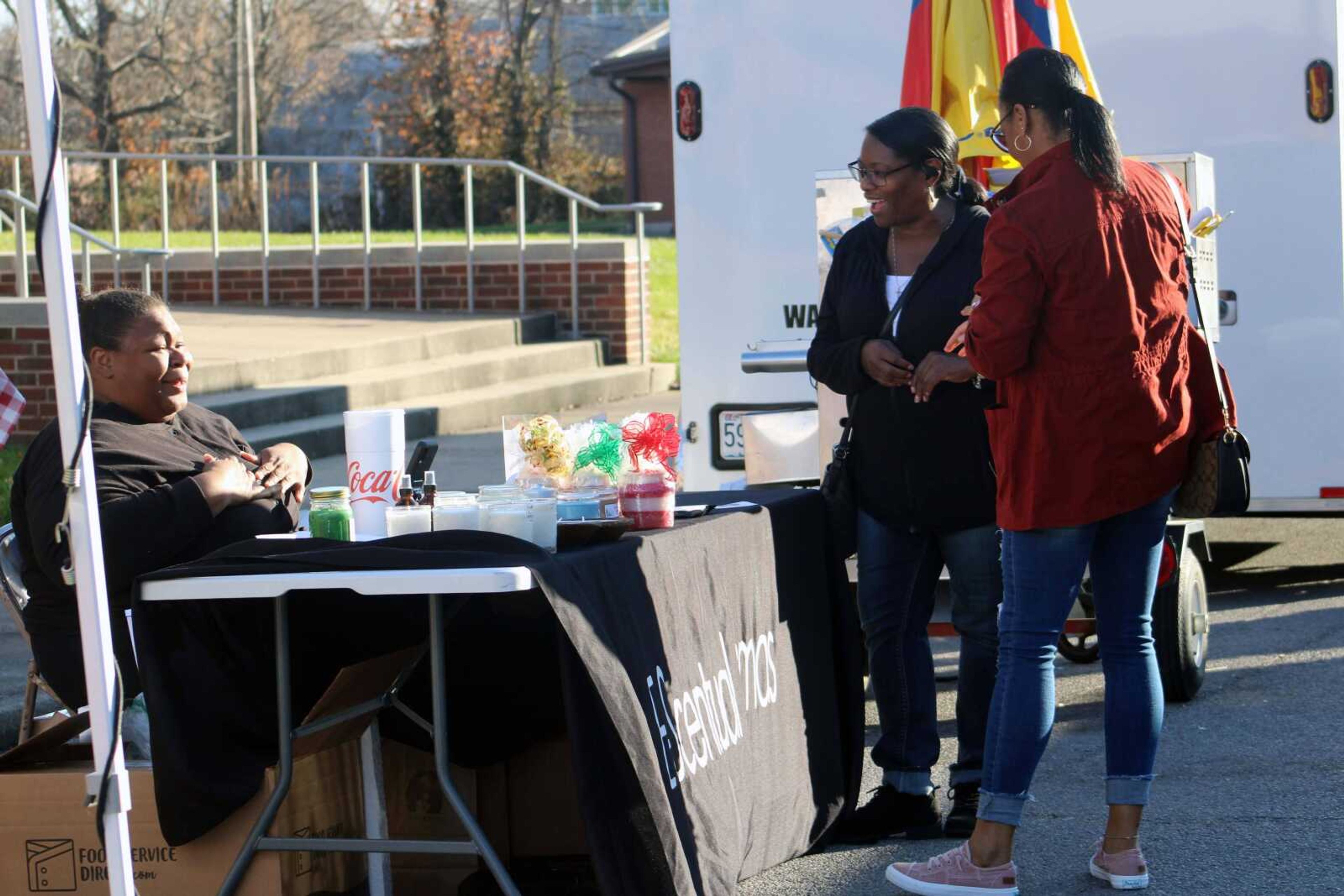 Attendees speak with a vendor at the third annual Old Town Cape, Inc. Holiday Bazaar Saturday, Dec. 5, 2021, on Frederick Street in downtown Cape Girardeau.