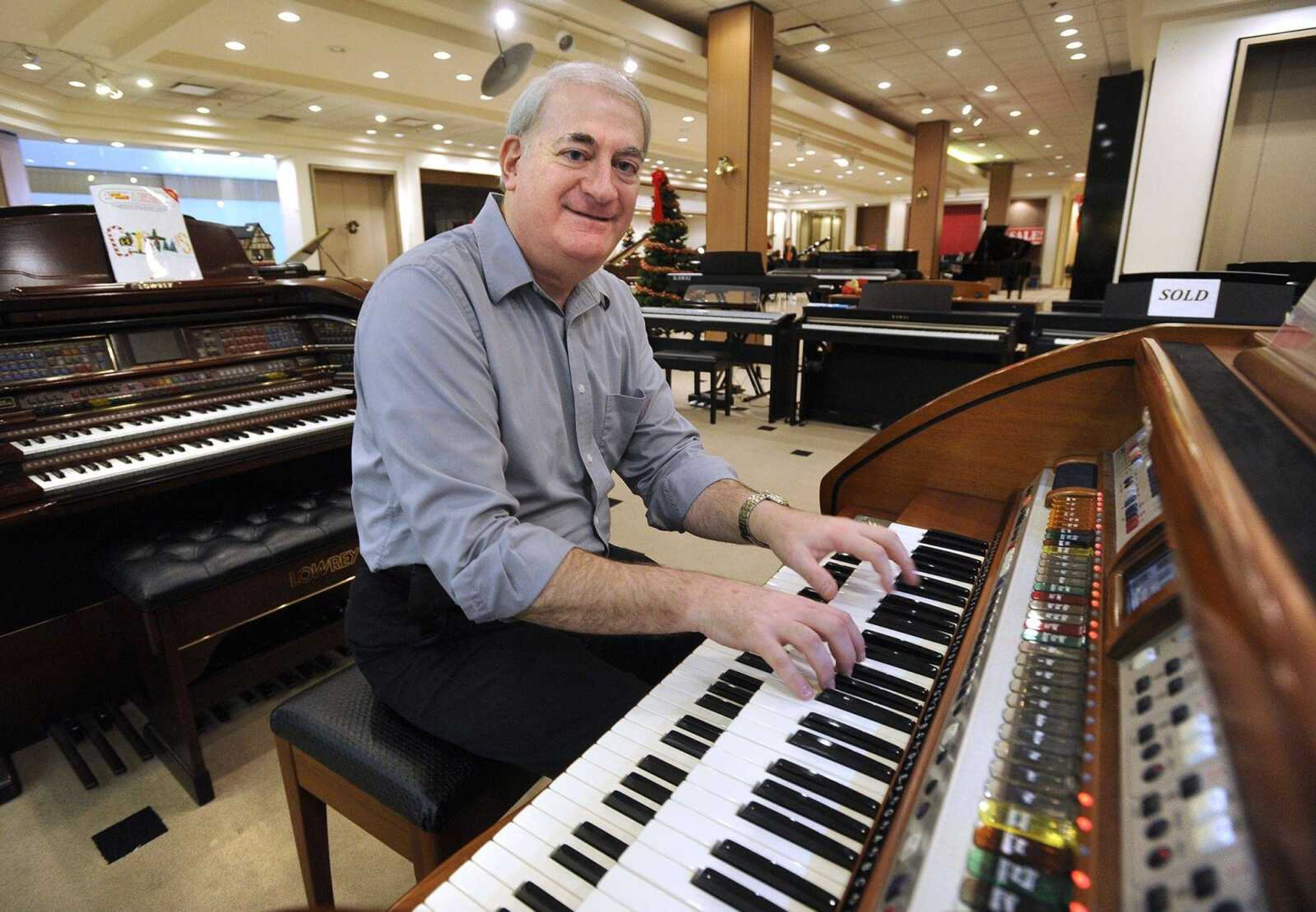 Howard Kessler, store manager, demonstrates Friday the Lowrey Inspire organ, which was used by St. Louis Cardinals organist Dwayne Hilton last season at Busch Stadium, at Lacefield Music in West Park Mall in Cape Girardeau.