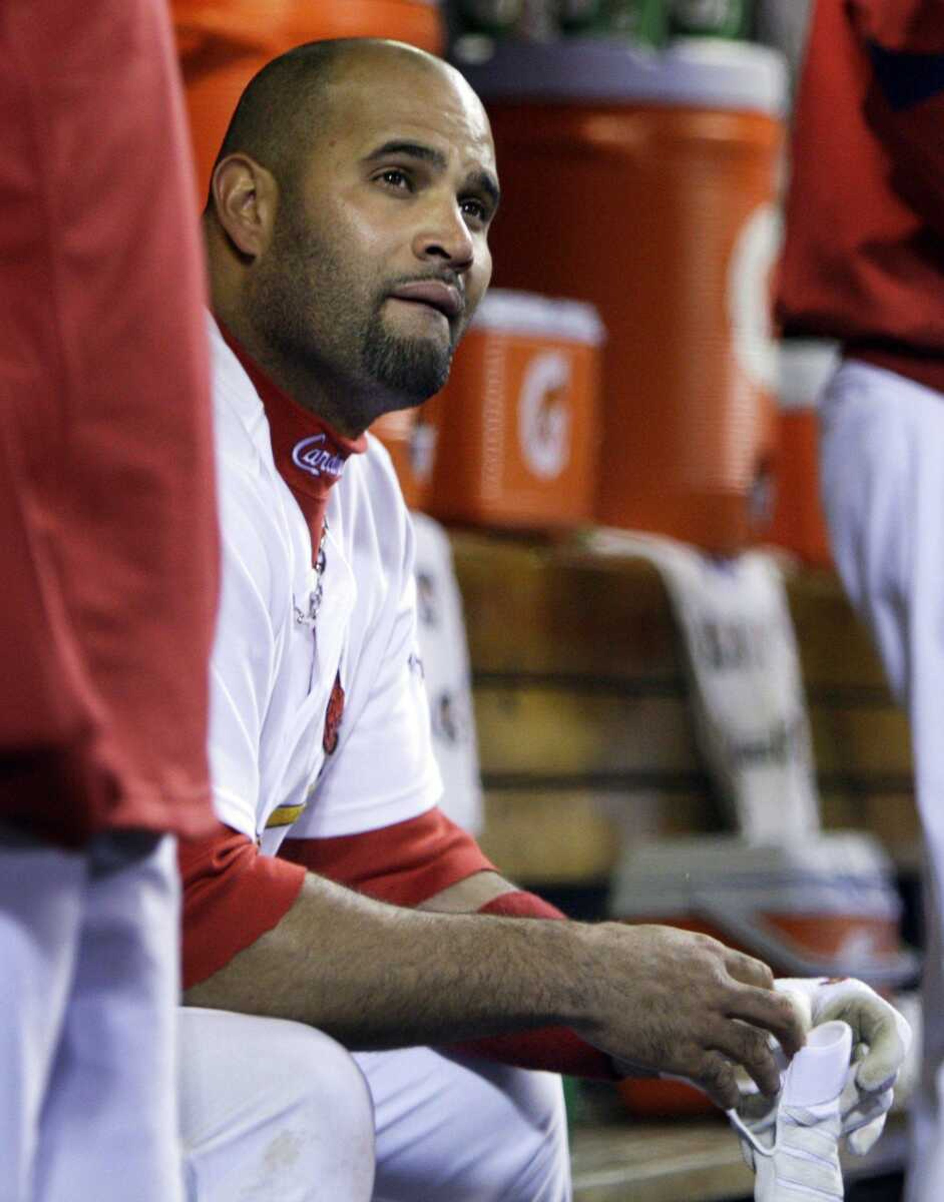 Albert Pujols sits in the dugout during Game 3 of the National League division series against the Los Angeles Dodgers. Pujols has a year left on his contract with the Cardinals. (JEFF ROBERSON ~ Associated Press)