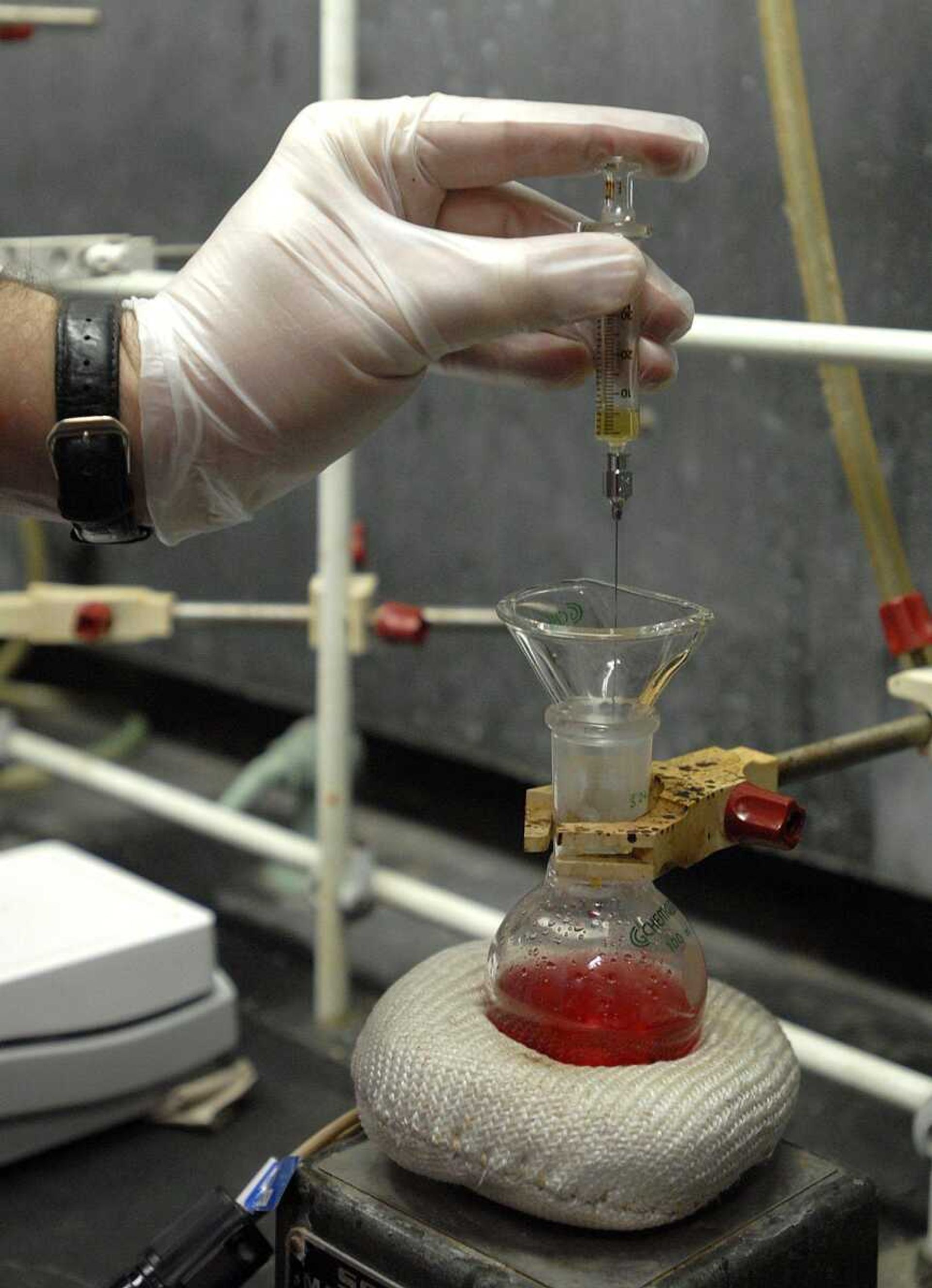 AARON EISENHAUER ~ aeisenhauer@semissourian.com
Bruce Hathaway uses a syringe to add a chemical to a mixture that will react overnight, part of a research project into a new drug Wednesday in one of the labs at Magill Hall on the Southeast Missouri State University Campus.