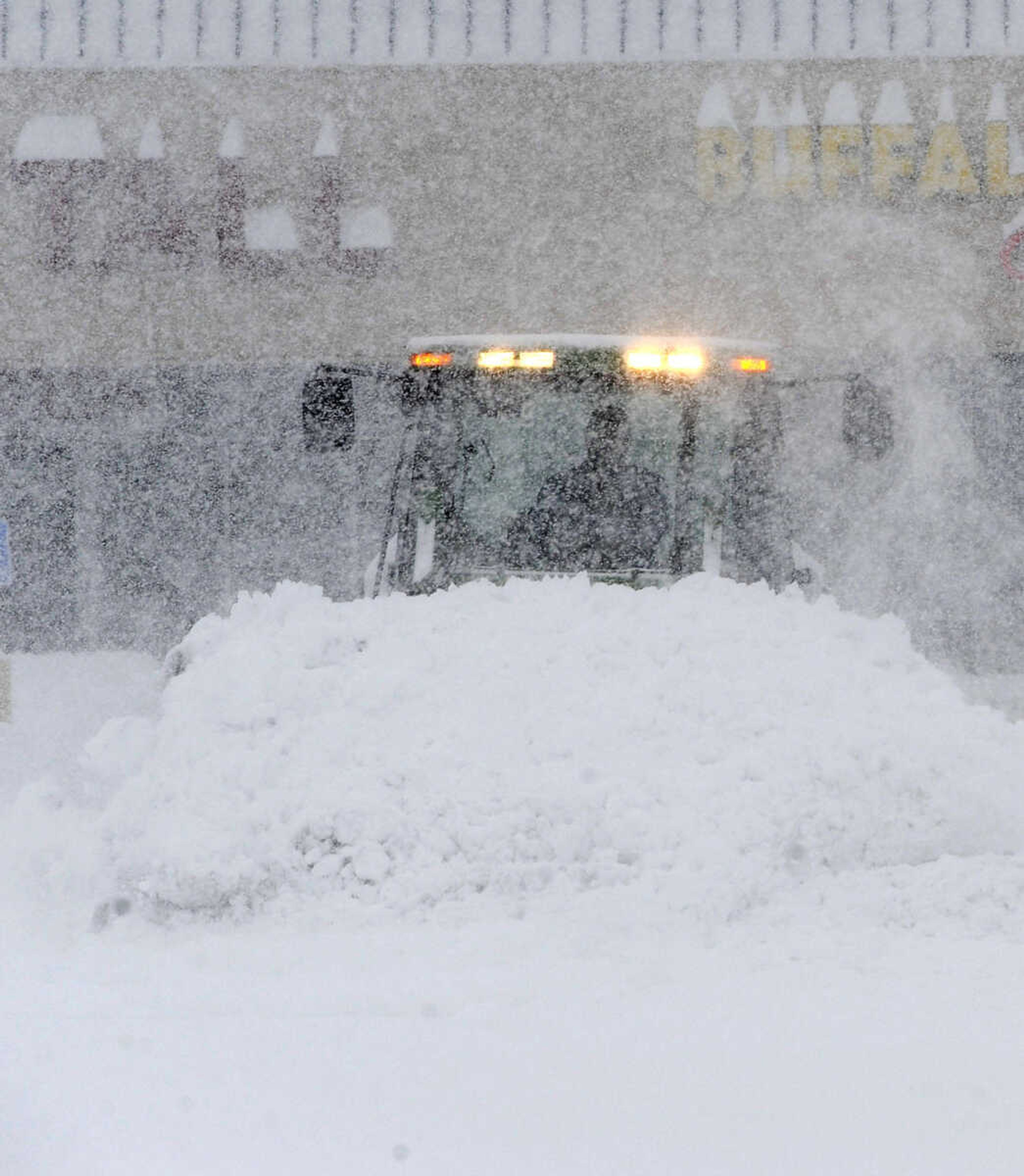 FRED LYNCH ~ flynch@semissourian.com
A snow plow works to clear the Town Plaza parking lot Monday morning, Feb. 16, 2015 in Cape Girardeau.