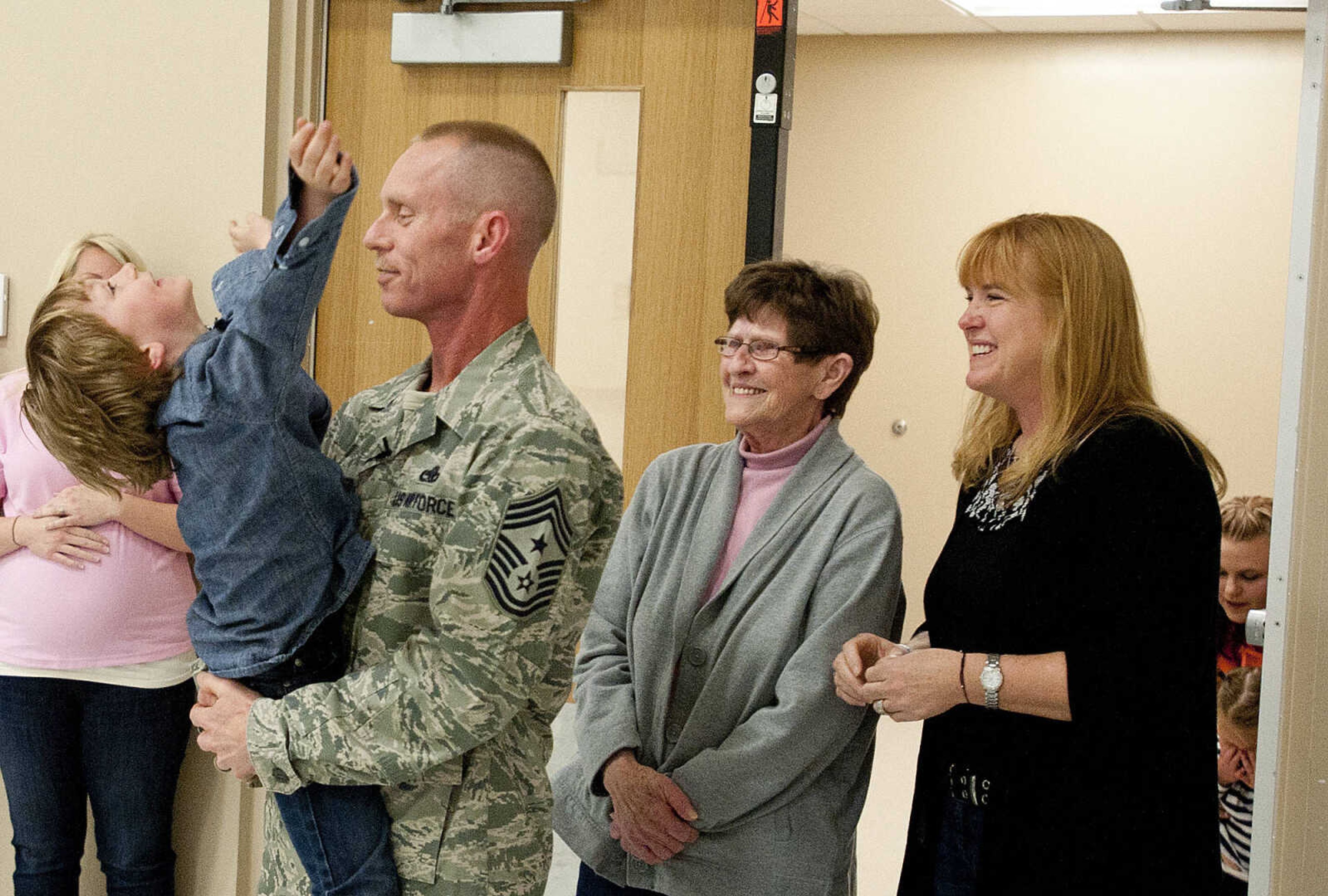 Gabriel Weimer, 6, hugs his father, Command Chief Master Sgt. Geoff Weimer as his mother LeAnne Weimer, right, and grandmother Doris Weimer look on Friday, March 14, at Franklin Elementary School in Cape Girardeau. Sgt. Weimer is on leave from the Air Force after being deployed in the Middle East since Oct., and surprised his three sons, Geordan, 11, Eli, 9, and Gabriel, 6, in their respective classes.