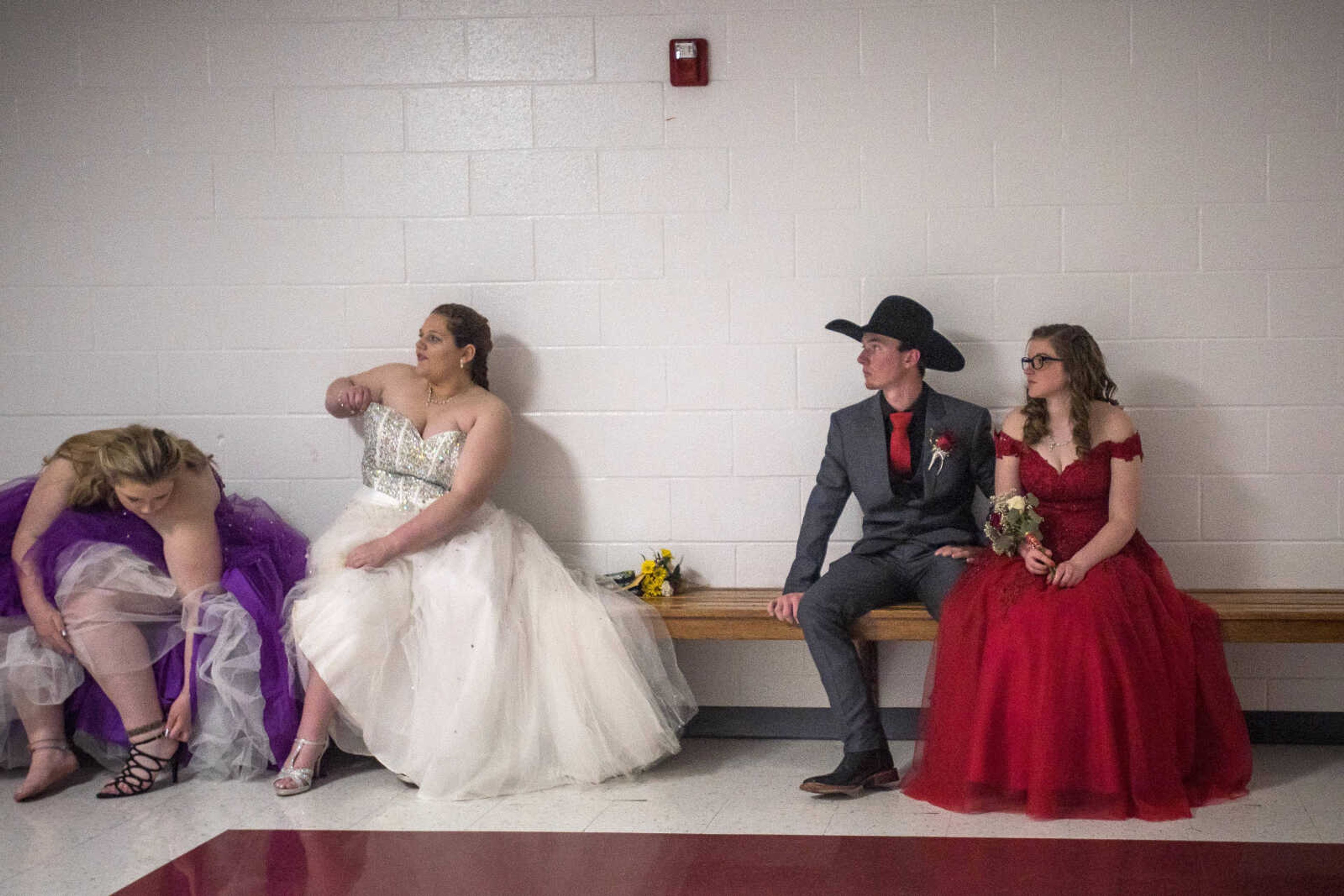 Kelly juniors Colton Sanders and Haley Dodd, right, wait on a bench alongside Destiny Hicks, far left, and Caylie Daniels before prom Saturday, April 6, 2019, at Kelly High School in Benton. 
Sanders said he chose to wear his cowboy hat as a nod to his extracurricular passion, rodeo.