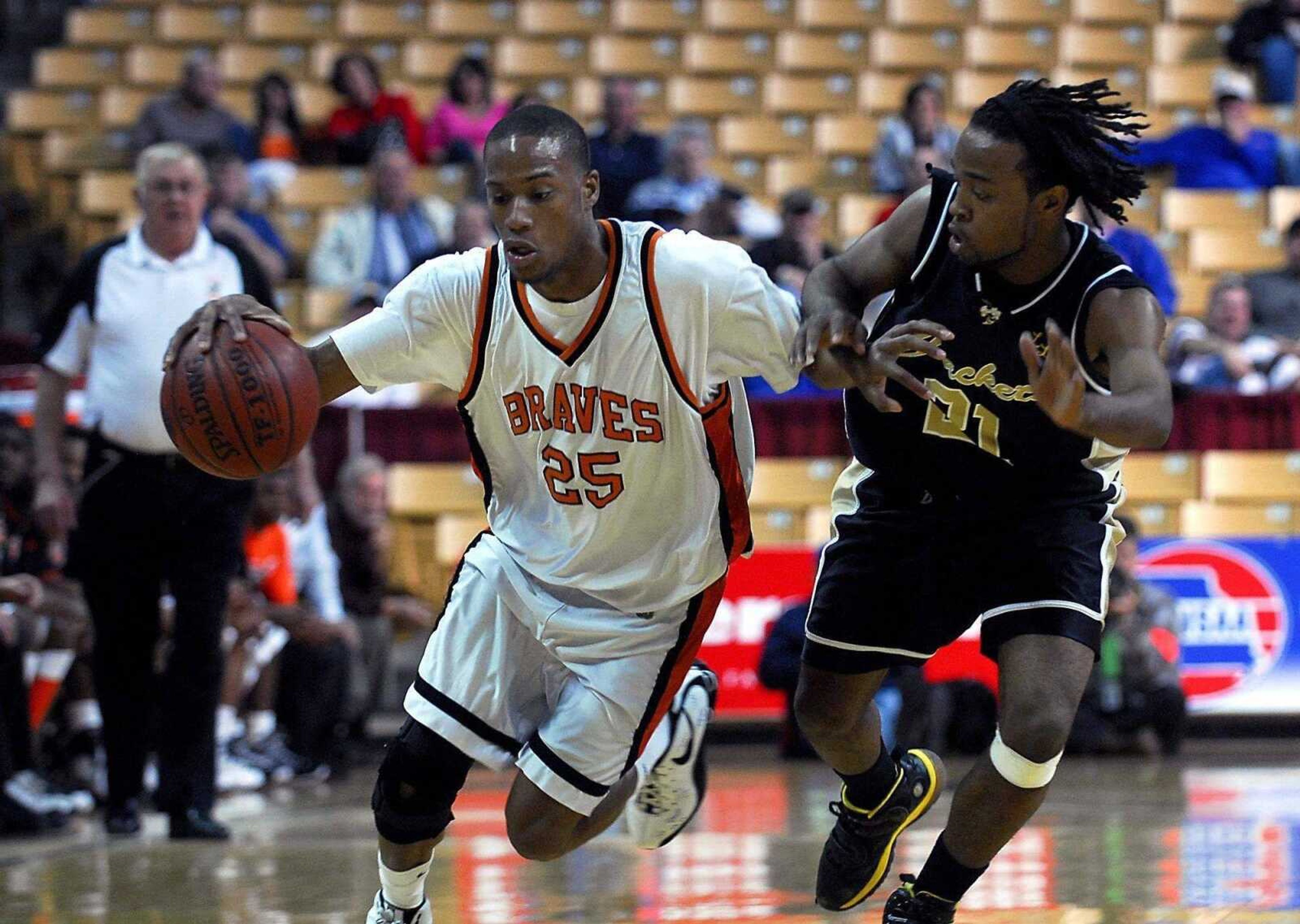 KIT DOYLE ~ kdoyle@semissourian.comScott County Central senior Randy Timmons drives past defender Jay Lee during their Class 1 semifinal game Thursday at Mizzou Arena in Columbia.