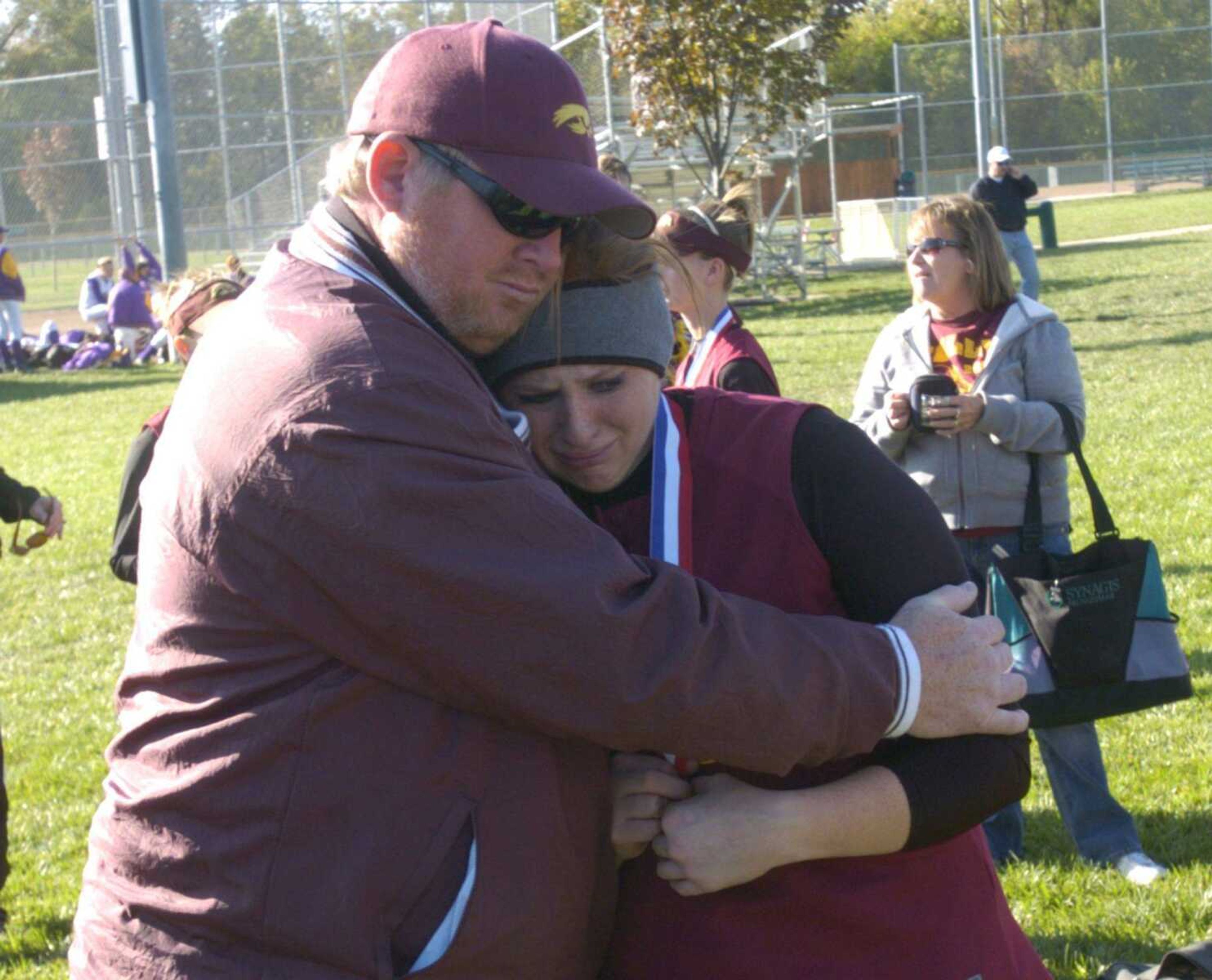 CHUCK WU ~ cwu@semissourian.com
Kelly pitcher Danielle Dock receives comfort from her father after the Hawks' Class 2 state championship game Saturday in St. Joseph.