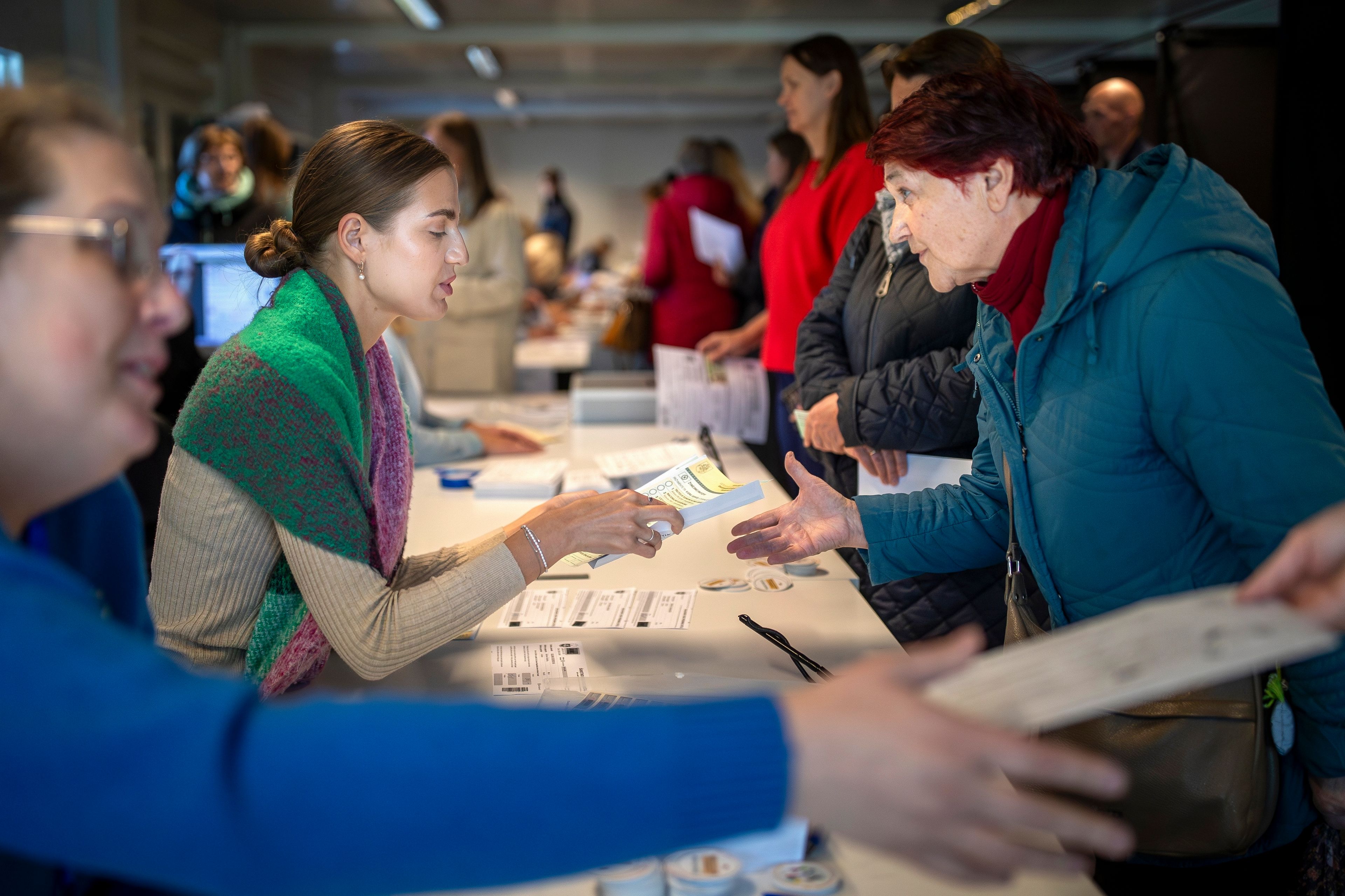 FILE - A woman arrives at a polling station during the advance parliamentary elections in Vilnius, Lithuania, Tuesday, Oct. 8, 2024. (AP Photo/Mindaugas Kulbis, File)