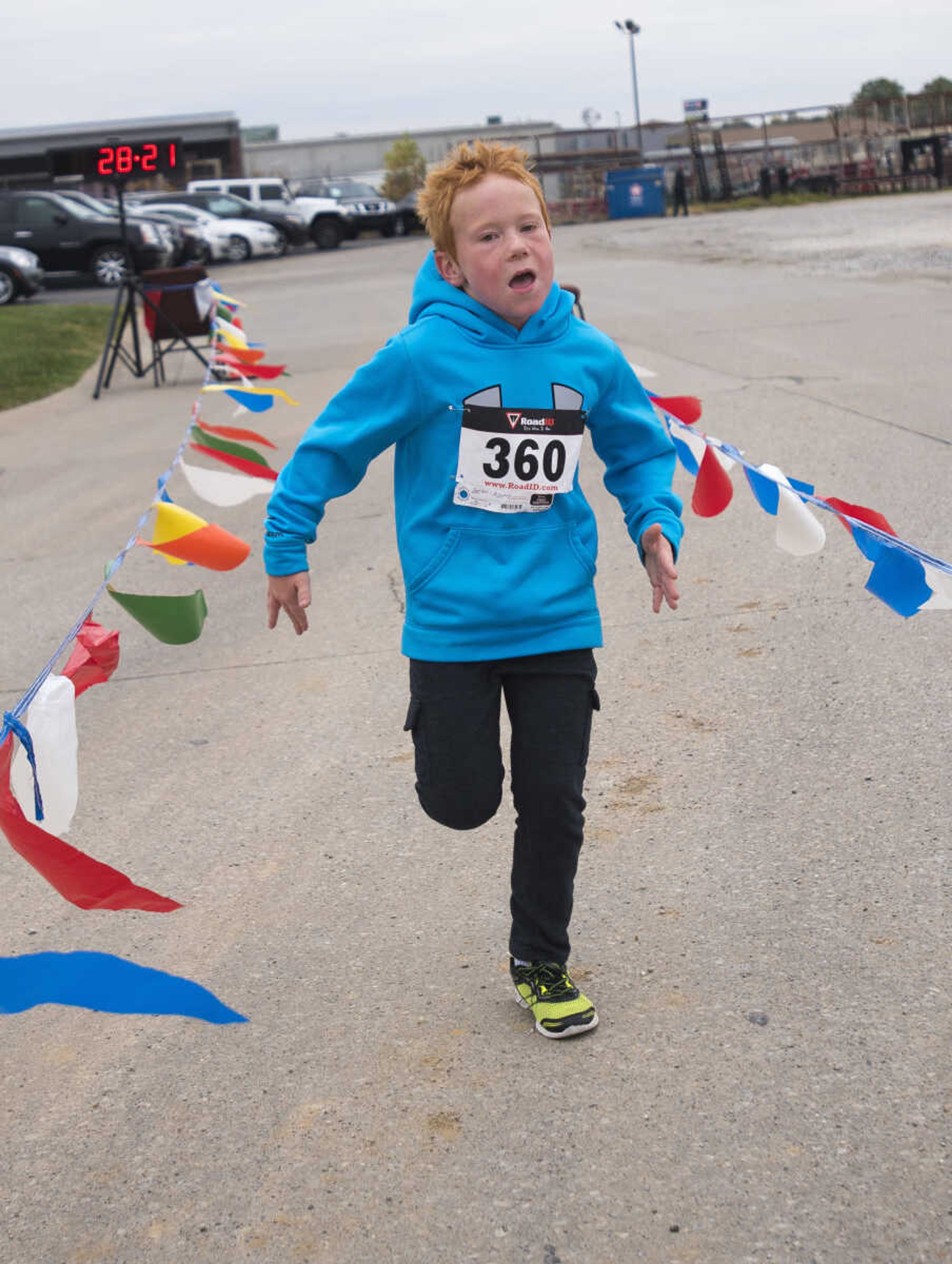 Nolan Turner crosses the finish line during the first Ghost and Goblin Gallop 5k race to raise money for the Crossroads Backpack Fair on Saturday, Oct. 28, 2017 in Jackson.