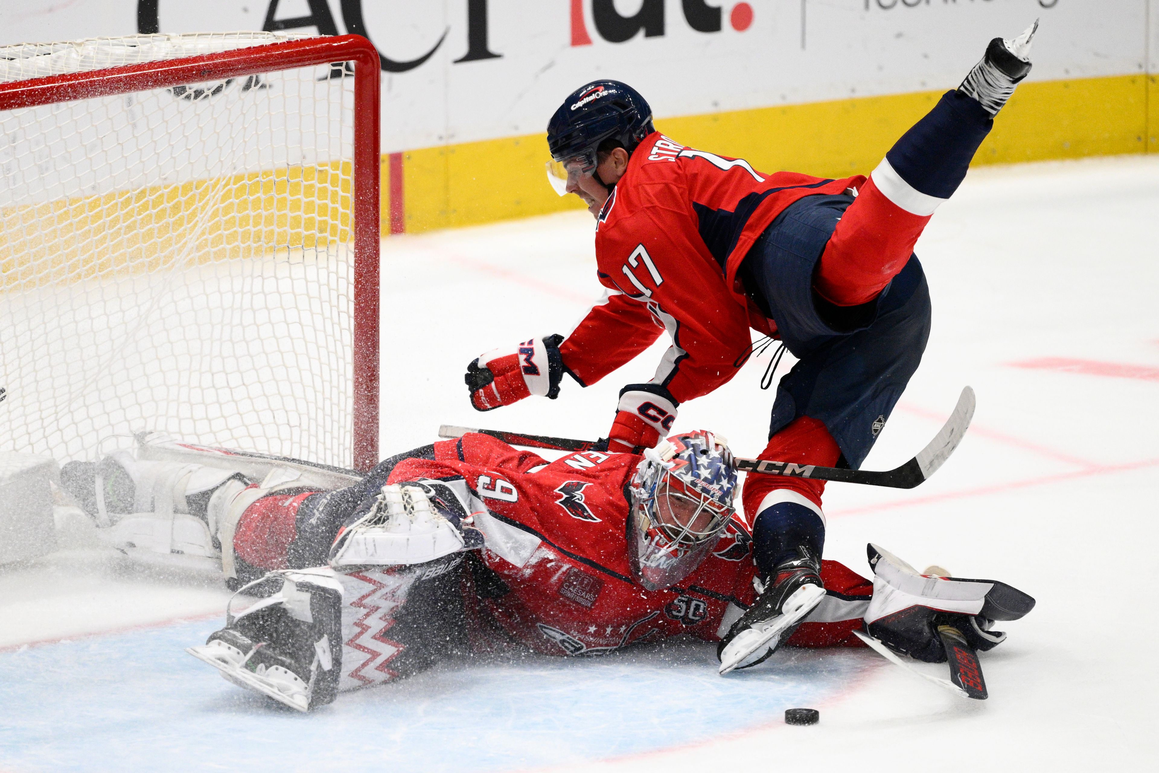 Washington Capitals center Dylan Strome (17) trips over Capitals goaltender Charlie Lindgren (79) during the third period of an NHL hockey game against the Pittsburgh Penguins, Friday, Nov. 8, 2024, in Washington. (AP Photo/Nick Wass)