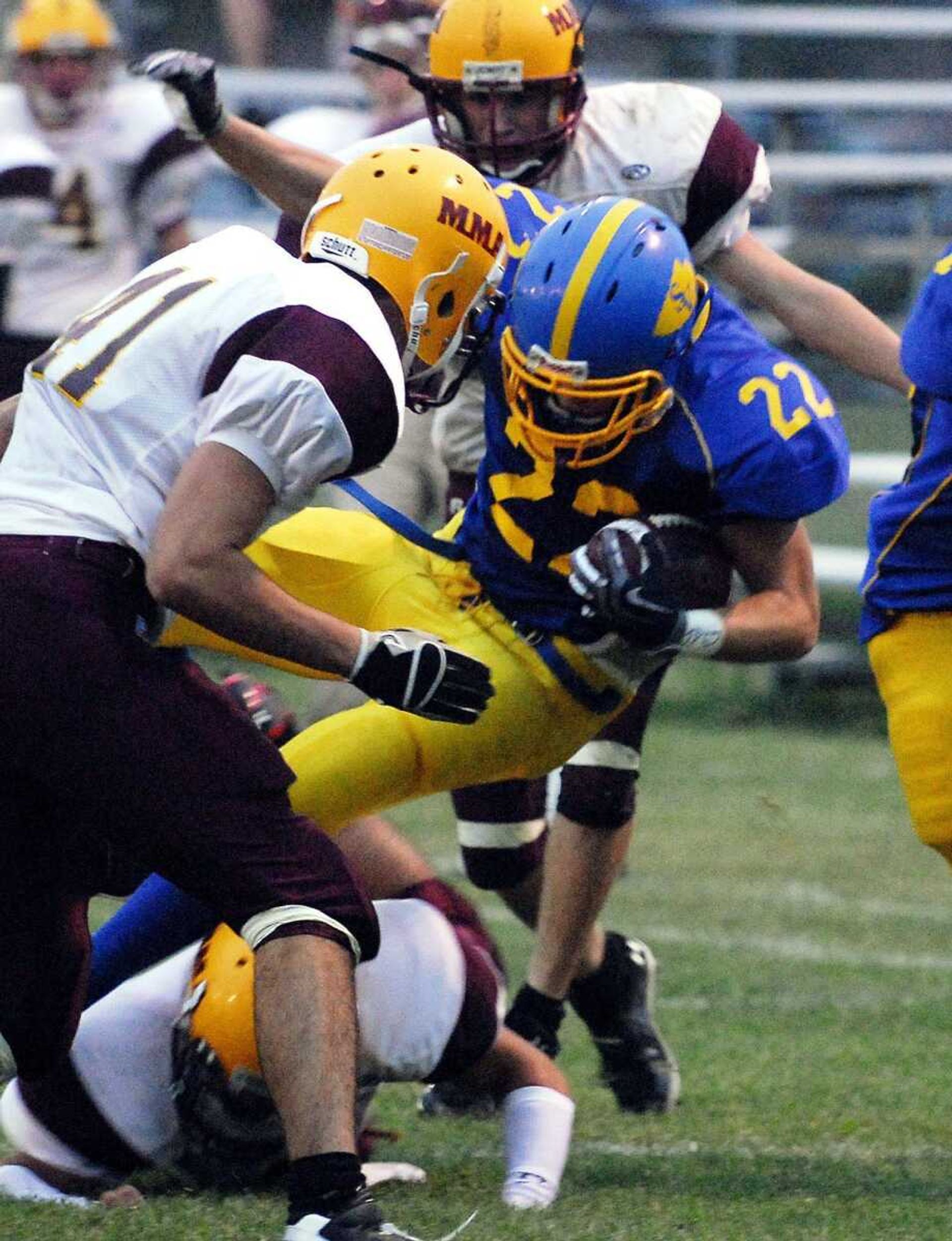 St. Vincent running back Ryan Weissing(22) gets taken down Friday, September 10, 2010 during their home game against Missouri Military. (Laura Simon)