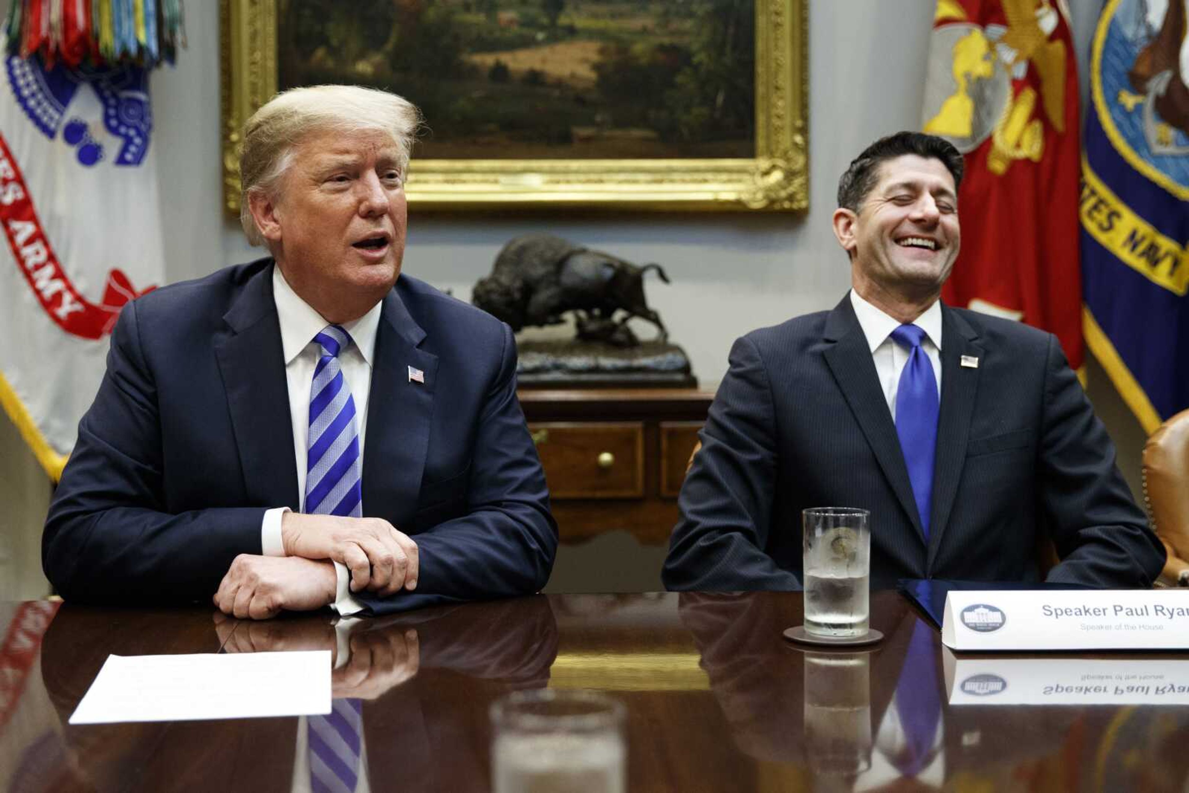 Speaker of the House Rep. Paul Ryan, R-Wis., laughs as he listens to President Donald Trump speak during a September meeting with Republican lawmakers in the Roosevelt Room of the White House in Washington.