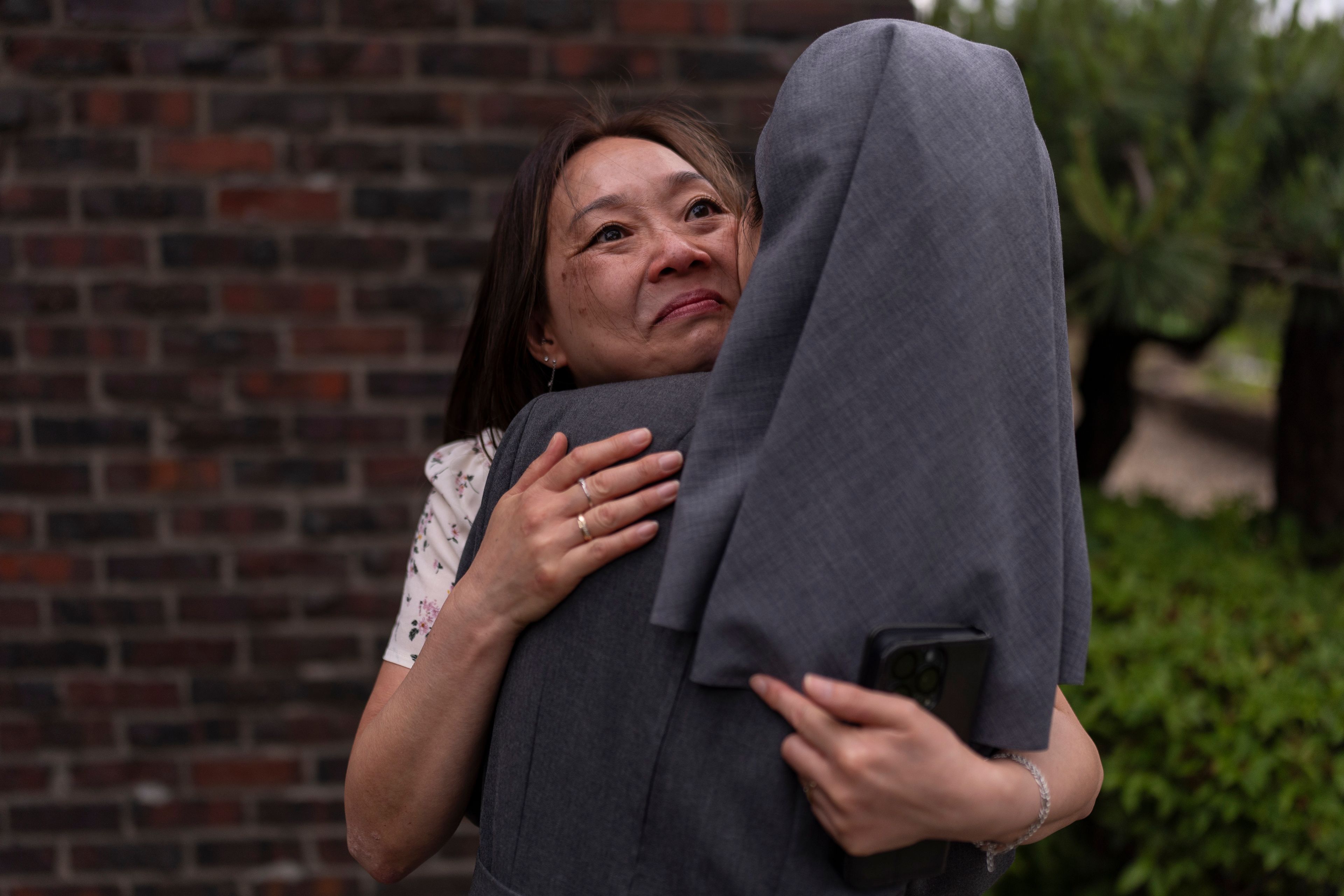 Maja Andersen, an adoptee visiting from Denmark to search for her birth family, hugs Sister Christina Ahn at Star of the Sea orphanage in Incheon, South Korea, Monday, May 20, 2024, while visiting the facility to look for details of her adoption. She had loved being hugged, the orphanage documents said, and had sparkling eyes. "Thank you so much, thank you so much," Andersen repeated in a trembling voice. There was comfort in that, she had been hugged, she had smiled. (AP Photo/Jae C. Hong)