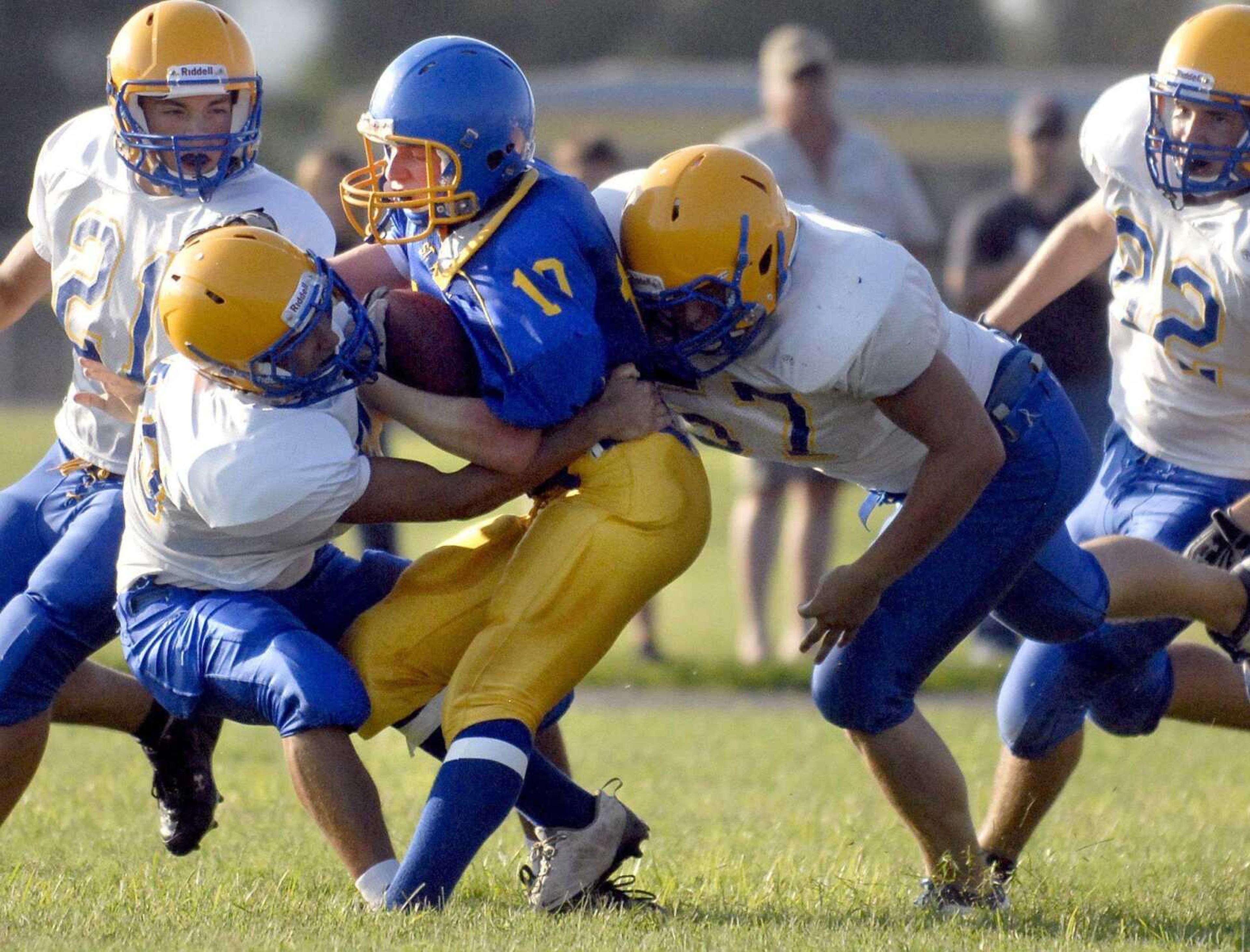 St. Vincent's Jesse Francis is sandwiched between two Scott City defenders Friday, August 19, 2011 as Scott City High School hosts Perryville and St. Vincent's during the 2011 high school football jamboree. (Laura Simon)