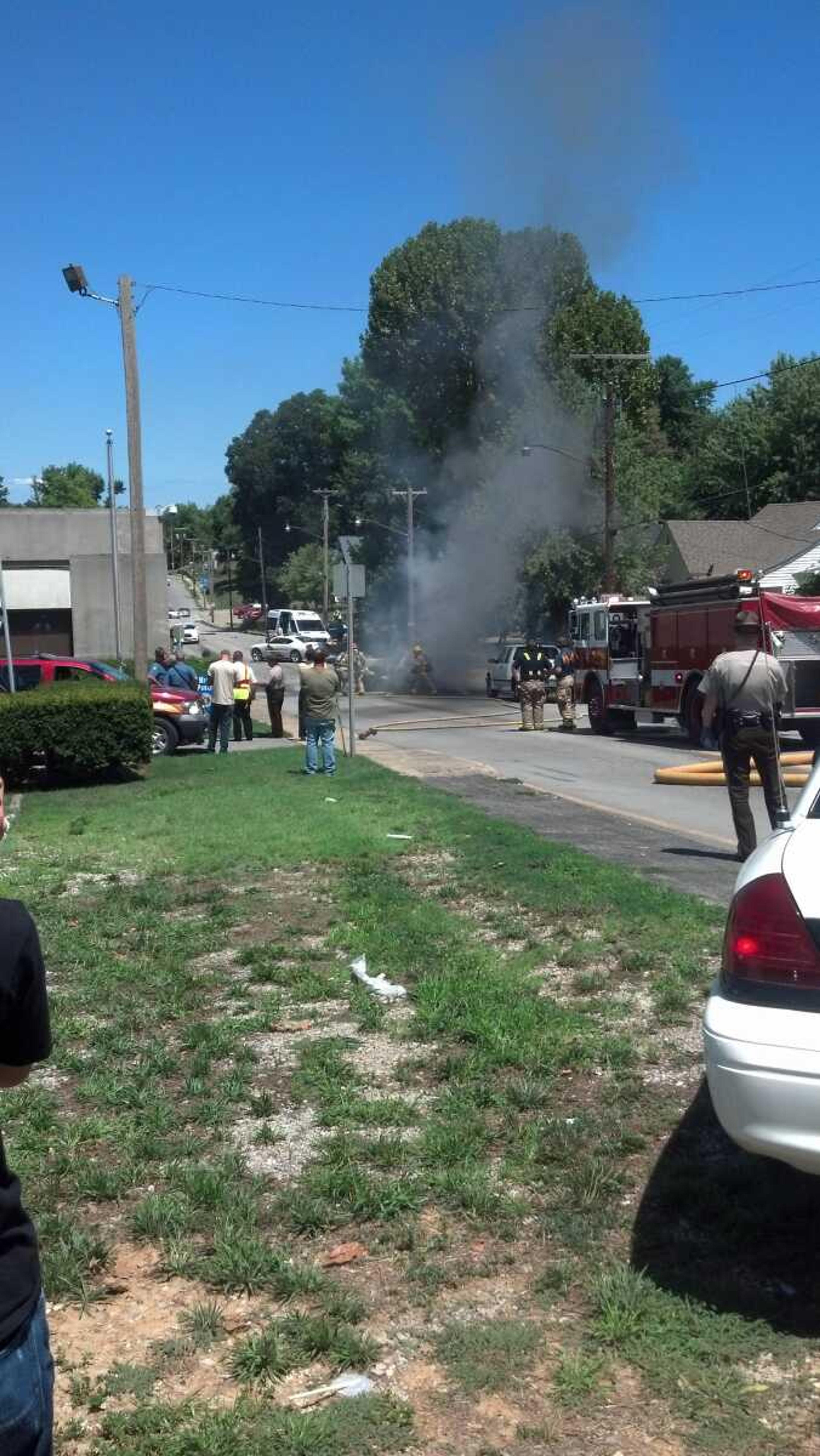 This photo submitted by Neil Randol shows a car smoking along U.S. 61 following a fiery crash in uptown Jackson on Monday, Aug. 6, 2012.